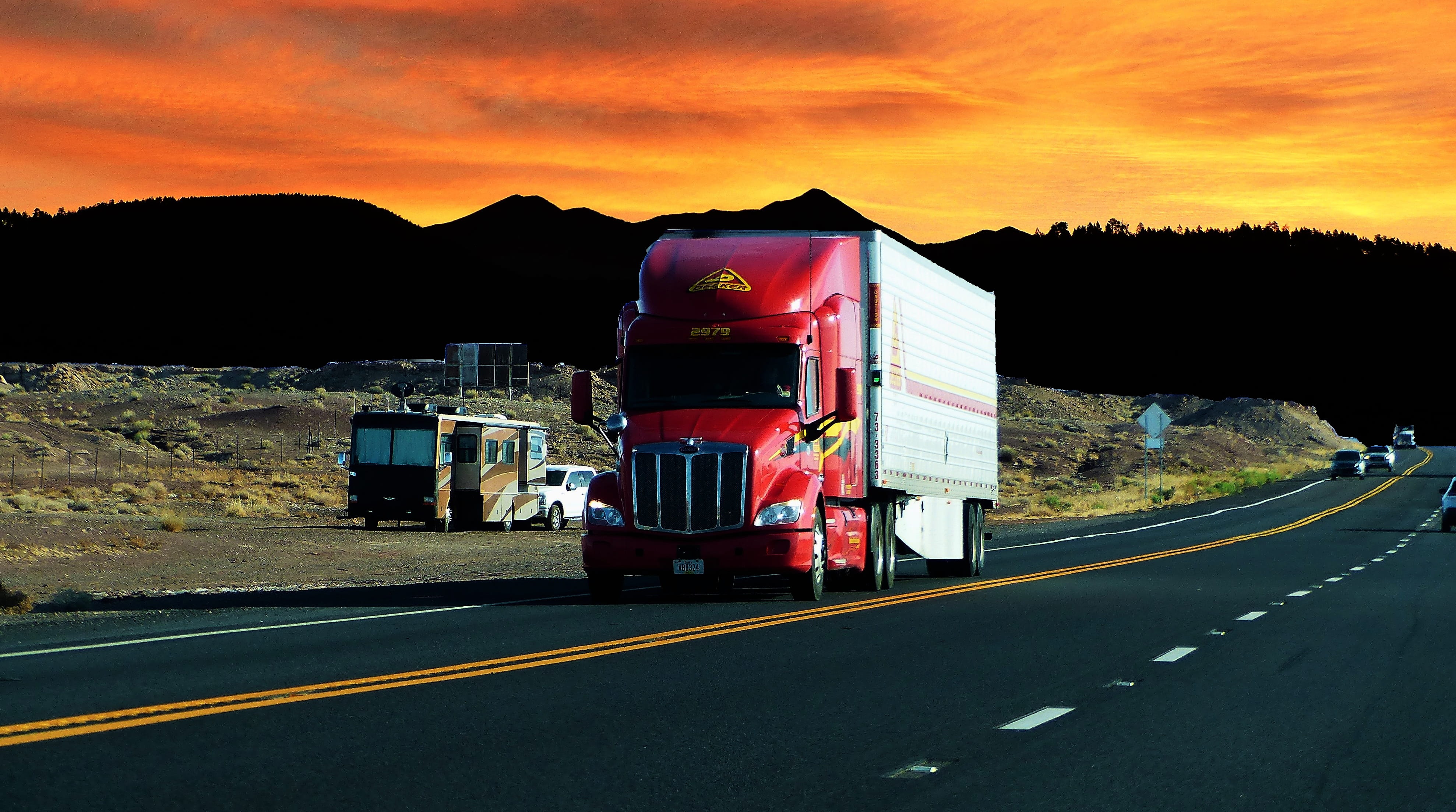 trailer, twilight, red, semi-truck, sunset, evening, motor vehicle, outdoors, 4K, mountain, motion, color, nature, sky, architecture, transportation, mode of transportation, HD Wallpaper