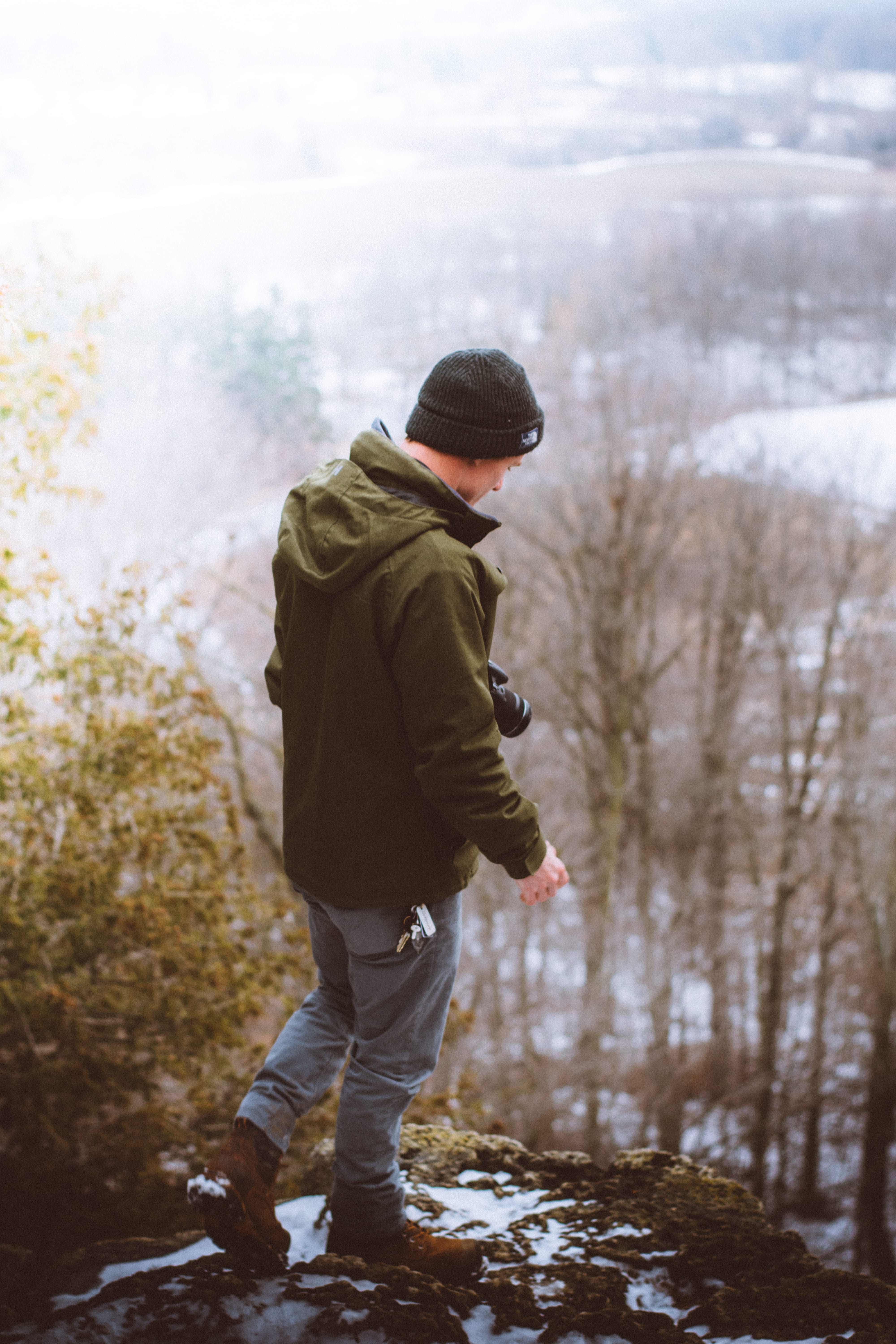 real people, blue, keys, rear view, clothing, camera, cap, hooded, jeans, one person, winter, formation, boots, warm clothing, hat, brown, rock, nature, Phone HD Wallpaper