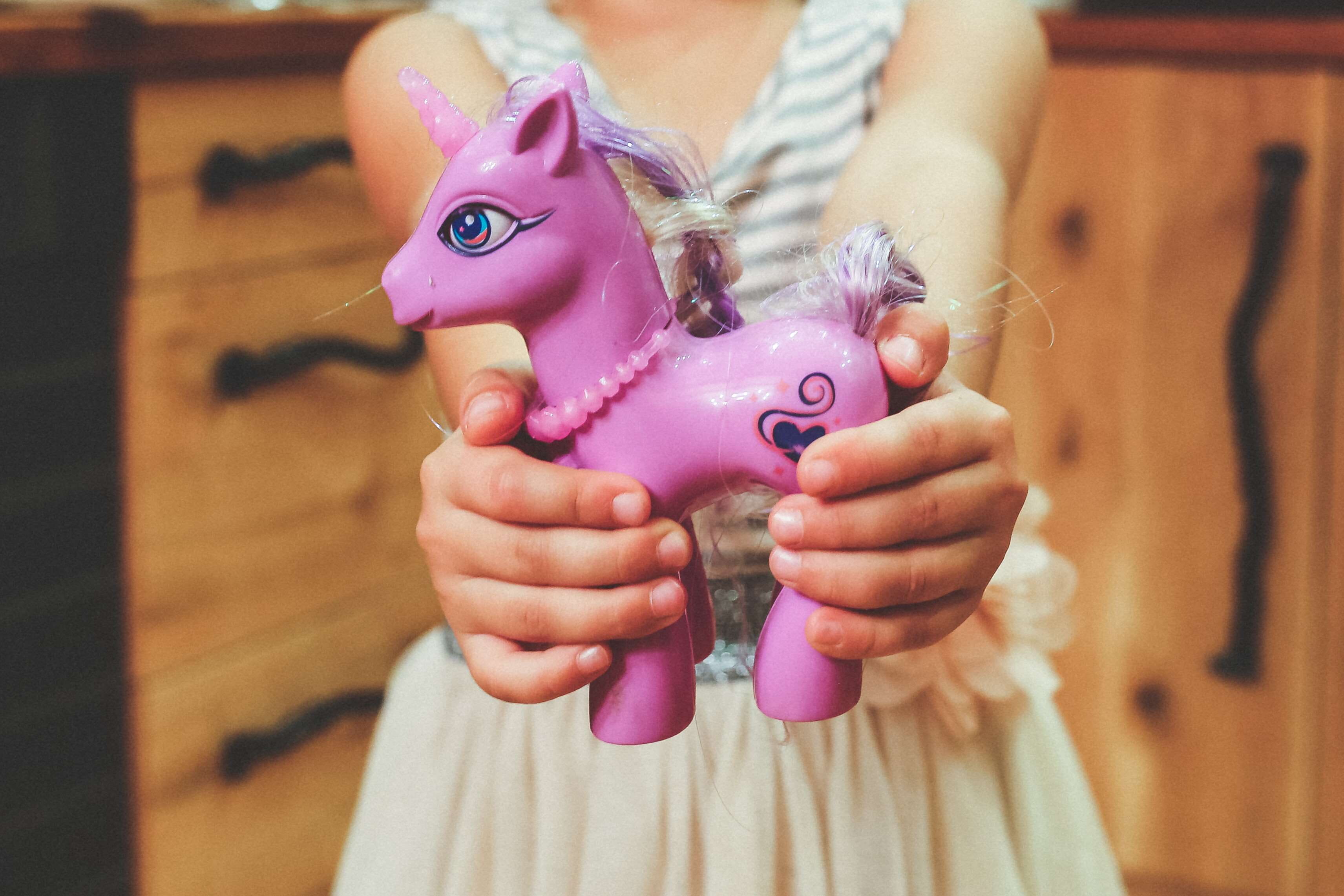 pink color, 2K, hand, front view, one person, real people, childhood, child, close-up, toy, savings, girl, horse, playing, kid, kindergarten, representation, HD Wallpaper