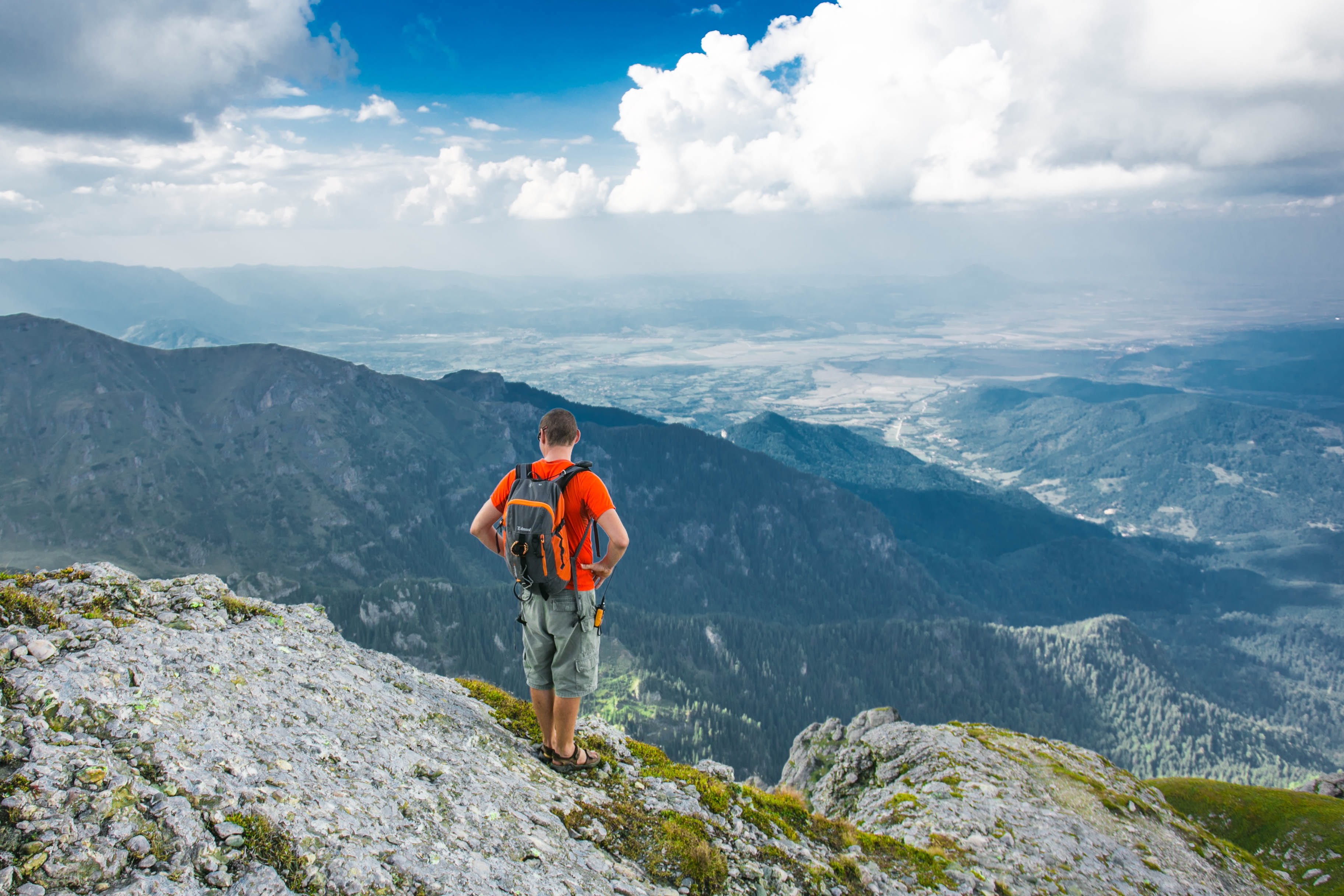 real people, hiker, valley, men, stand, front, adventure, man, edge, tranquil scene, non-urban scene, outdoors, 2K, beauty in nature, peak, high, lifestyles, HD Wallpaper