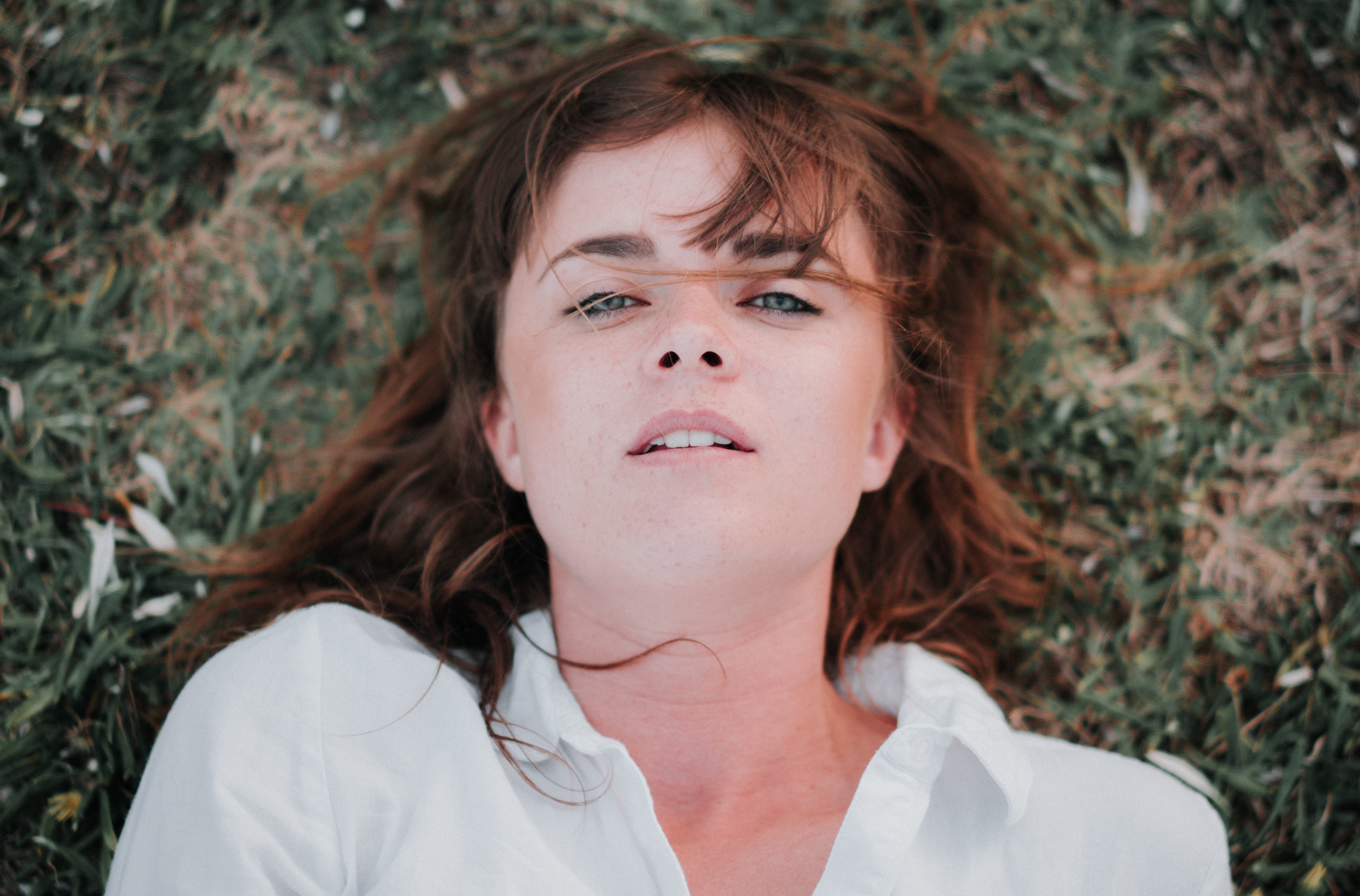 hair, innocence, contemplation, focus on foreground, nature, dyed red hair, one person, grass, girl, woman, girls, portrait, lying down, shirt, 5K, field, HD Wallpaper