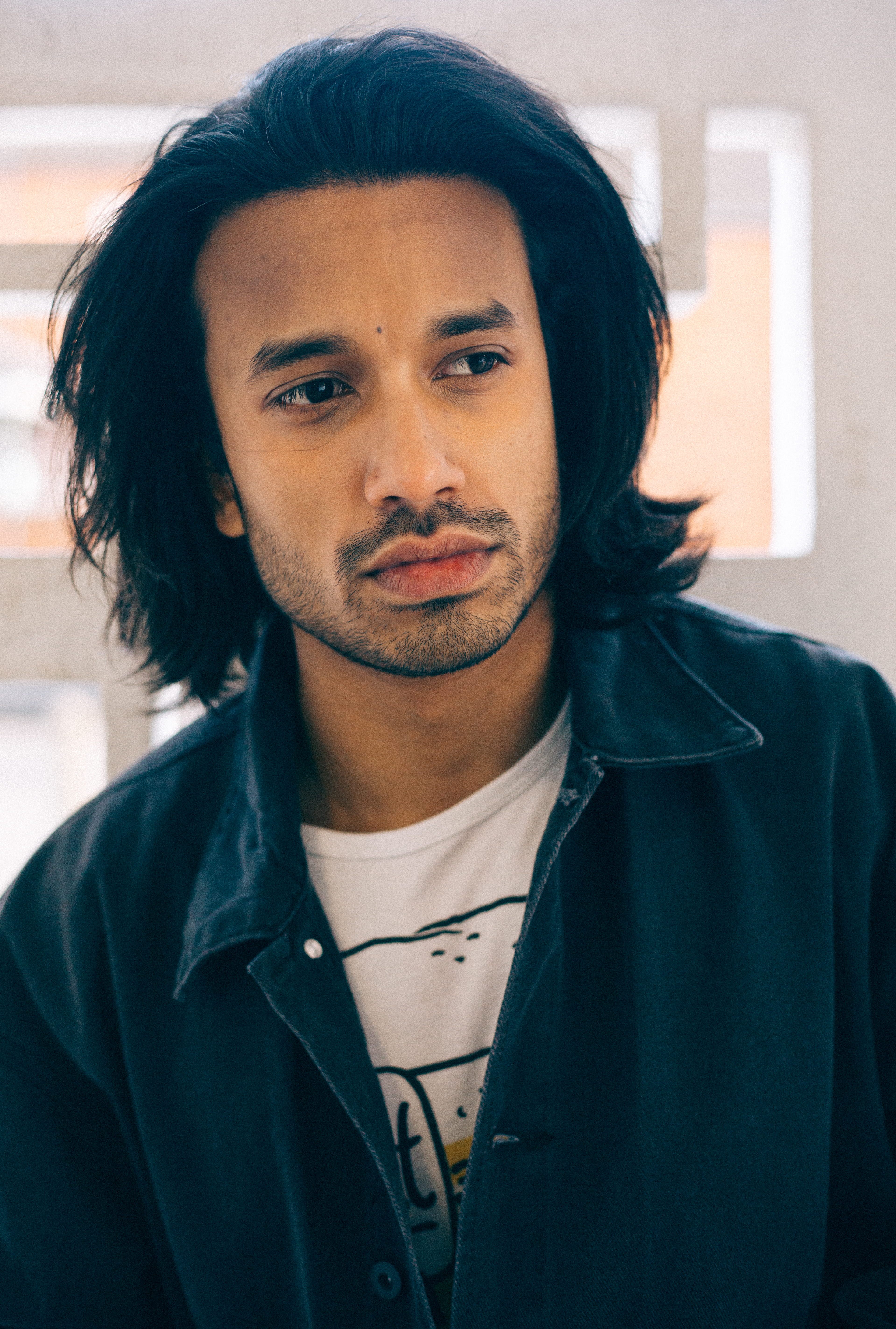 indoors, focus on foreground, black hair, standing, headshot, white, hairstyle, close-up, lifestyles, young adult, looking at camera, indoor, beard, portrait, Phone HD Wallpaper