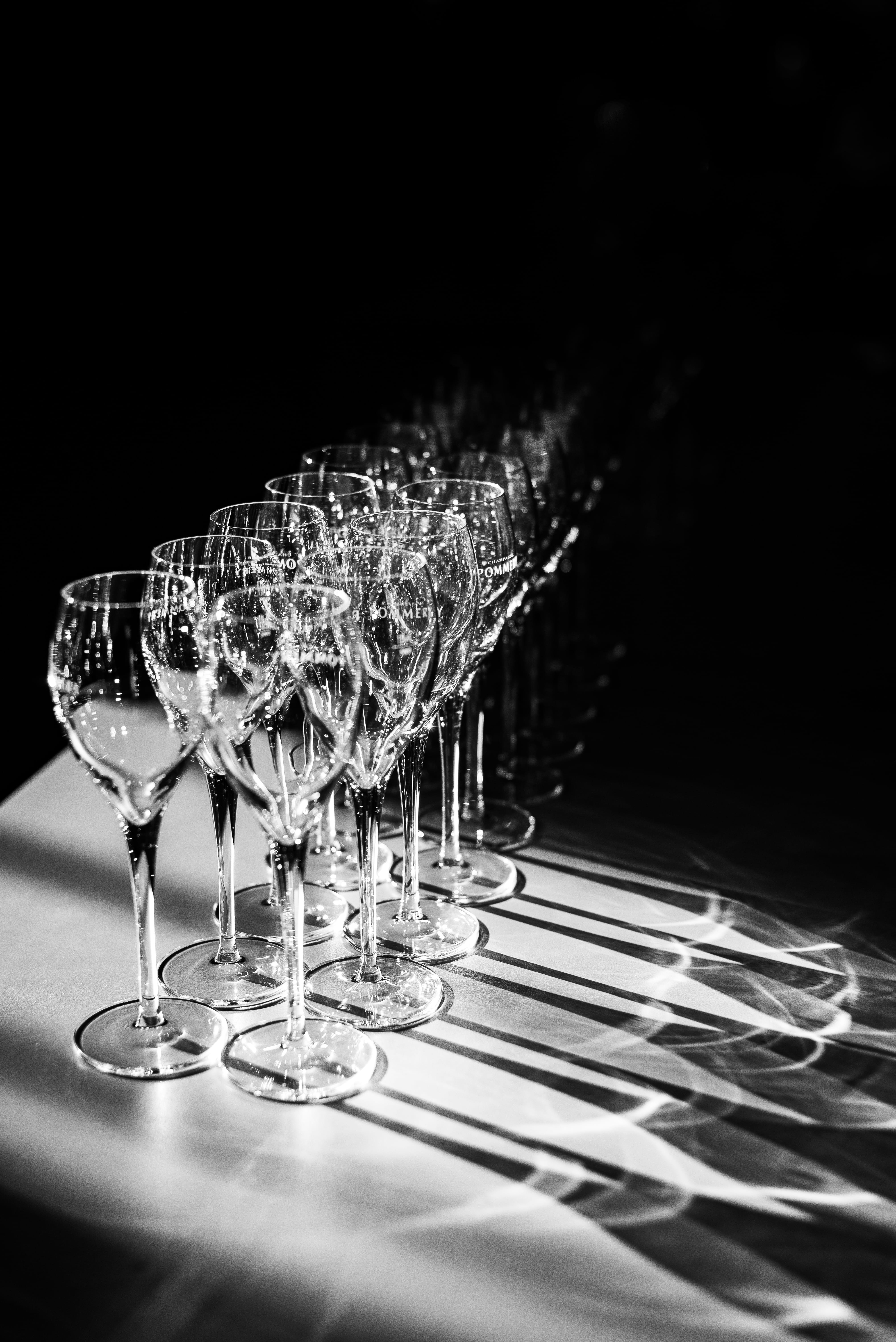 row, no people, setting, bar, goblet, low light, household equipment, food and drink, drinking glass, glass - material, 5K, indoors, black background, Phone HD Wallpaper