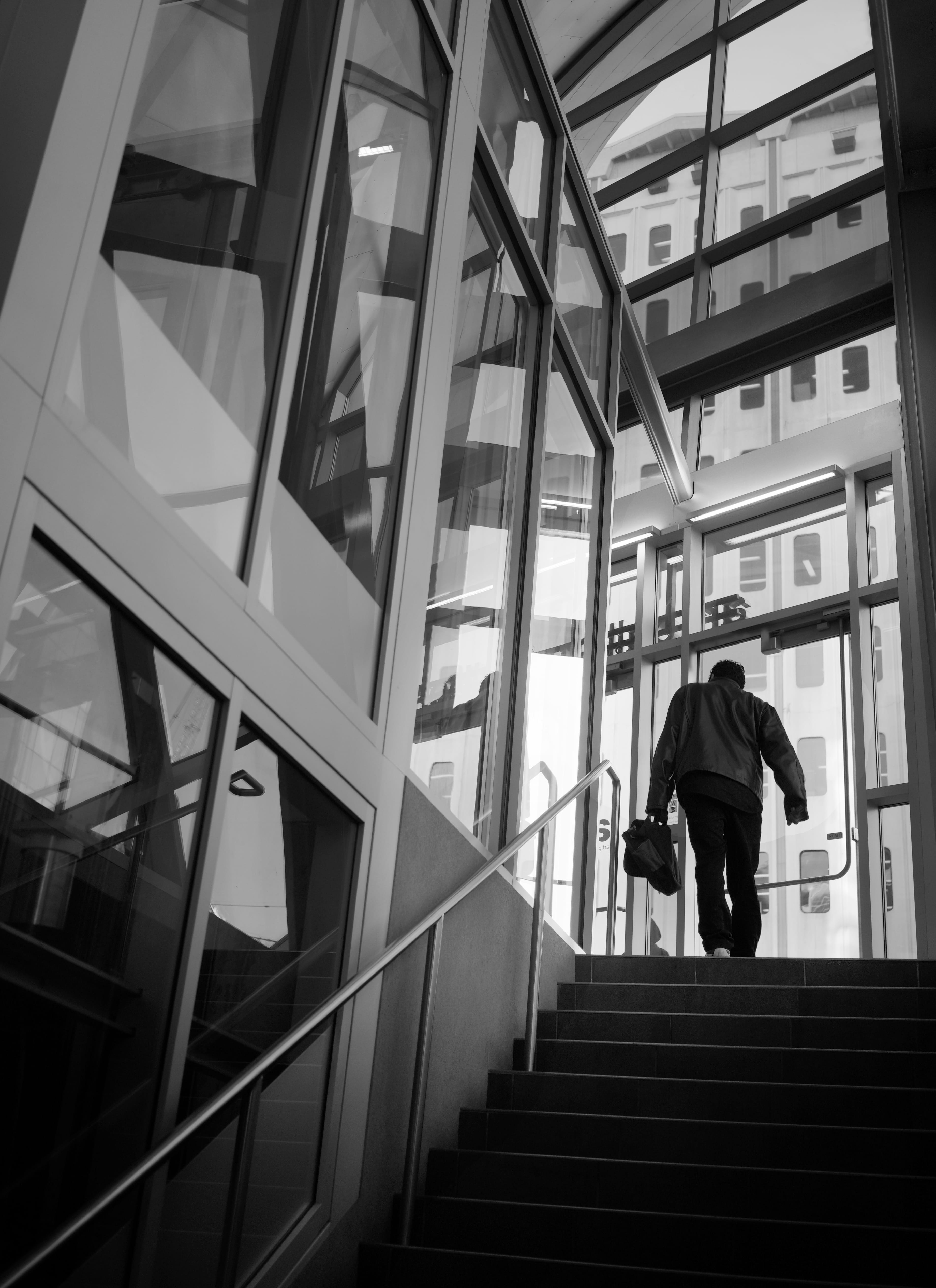 grayscale, lifestyles, photo, architecture, glass, human, real people, urban, indoors, men, low angle view, rear view, pedestrian, built structure, stairs, Phone HD Wallpaper