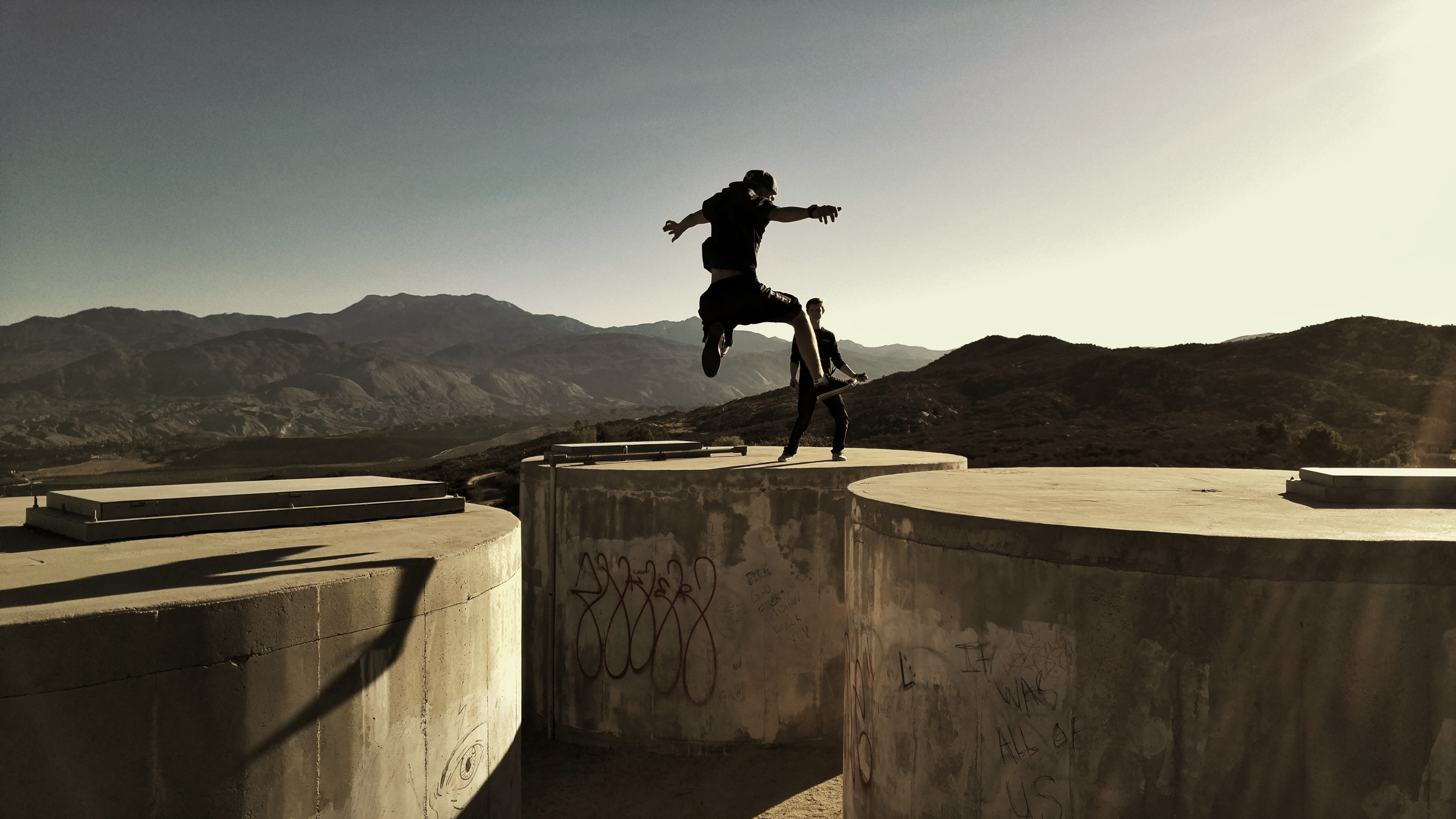 outdoors, stunt, 5K, one Person, jumping, real people, mountain range, sky, man, concrete, full Length, daytime, skateboard, photo, nature, lifestyles, HD Wallpaper