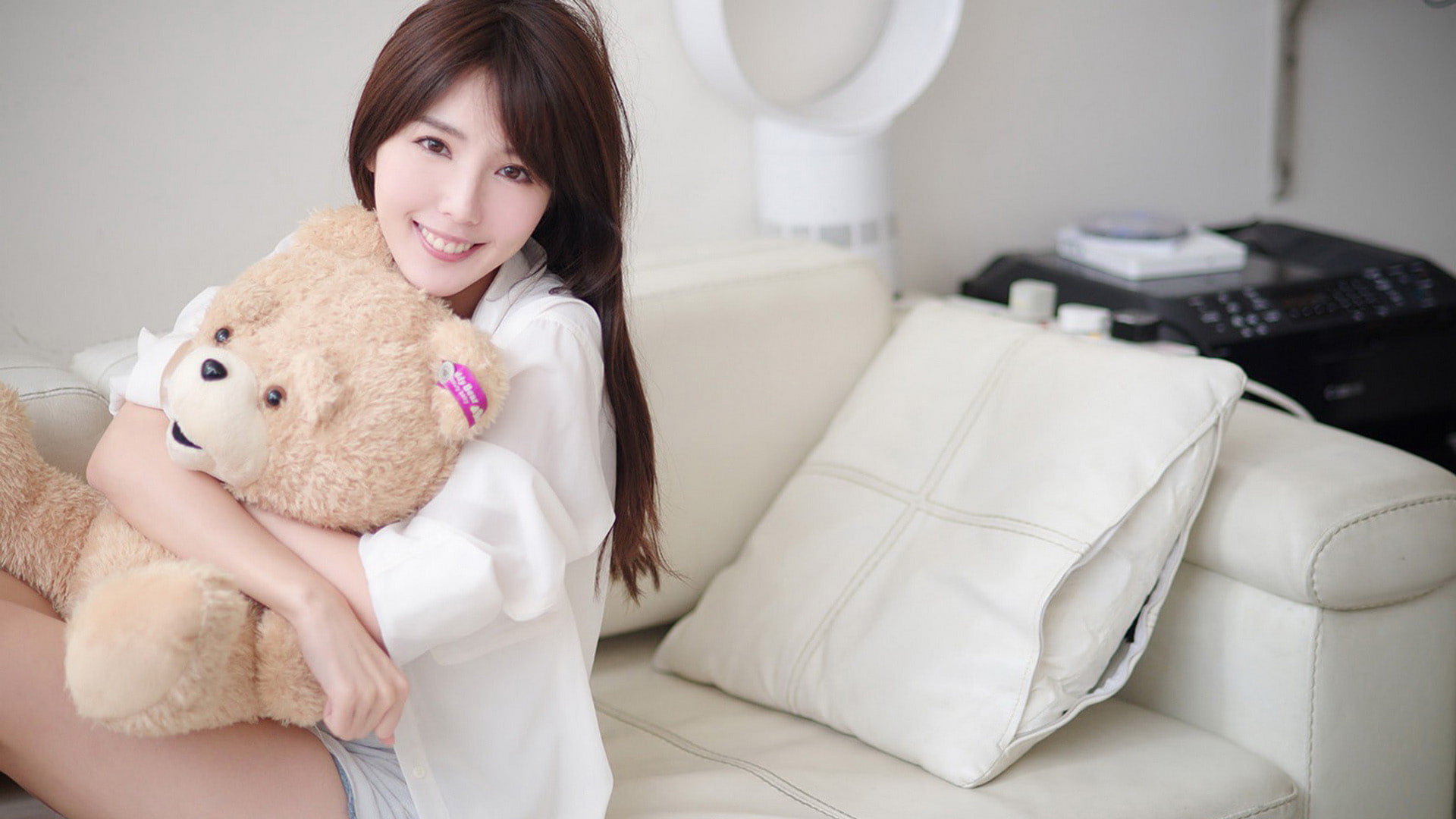 young adult, furniture, Asian, one person, smiling, sofa, toy, model, emotion, childhood, sitting, photography, domestic room, happiness, waist up, couch, HD Wallpaper