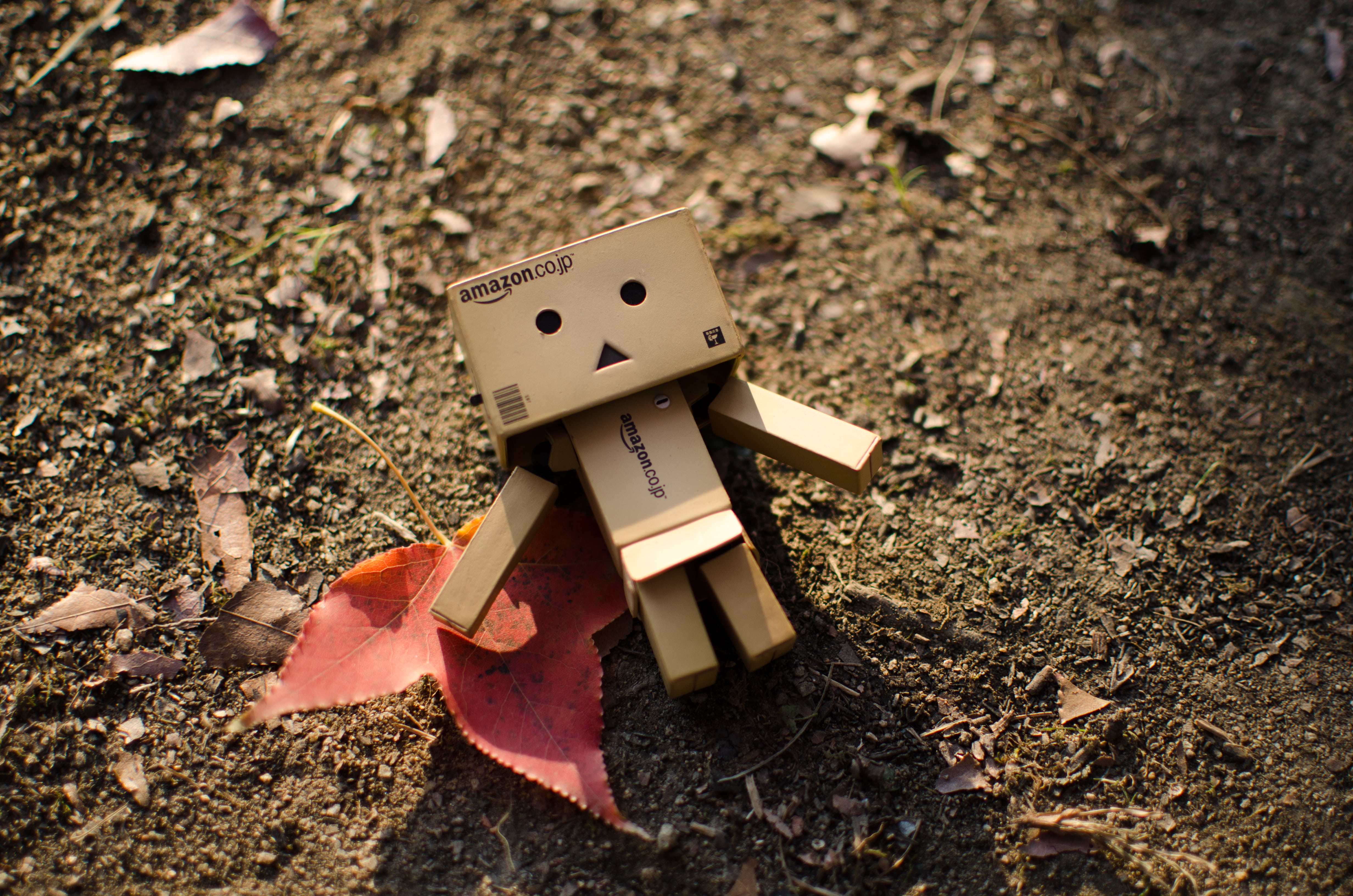 creativity, cardboard, ground, human representation, no people, red, day, dirt, high angle view, representation, 4K, robot, toy, outdoors, still life, HD Wallpaper