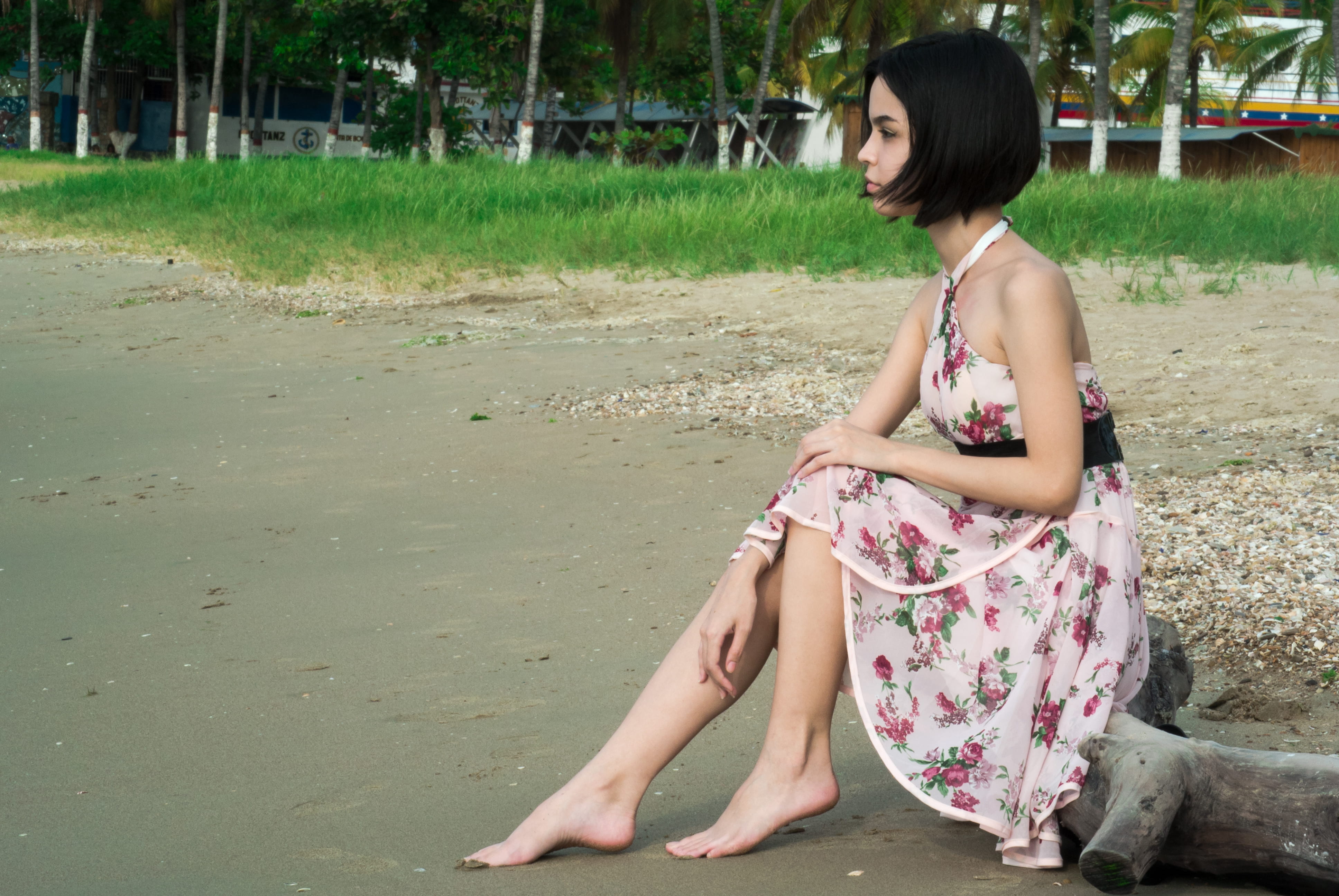 floral, girl, short hair, young adult, land, barefoot, dress, black hair, floral pattern, person, seating, fashion, one person, houses, driftwood, relaxation, HD Wallpaper