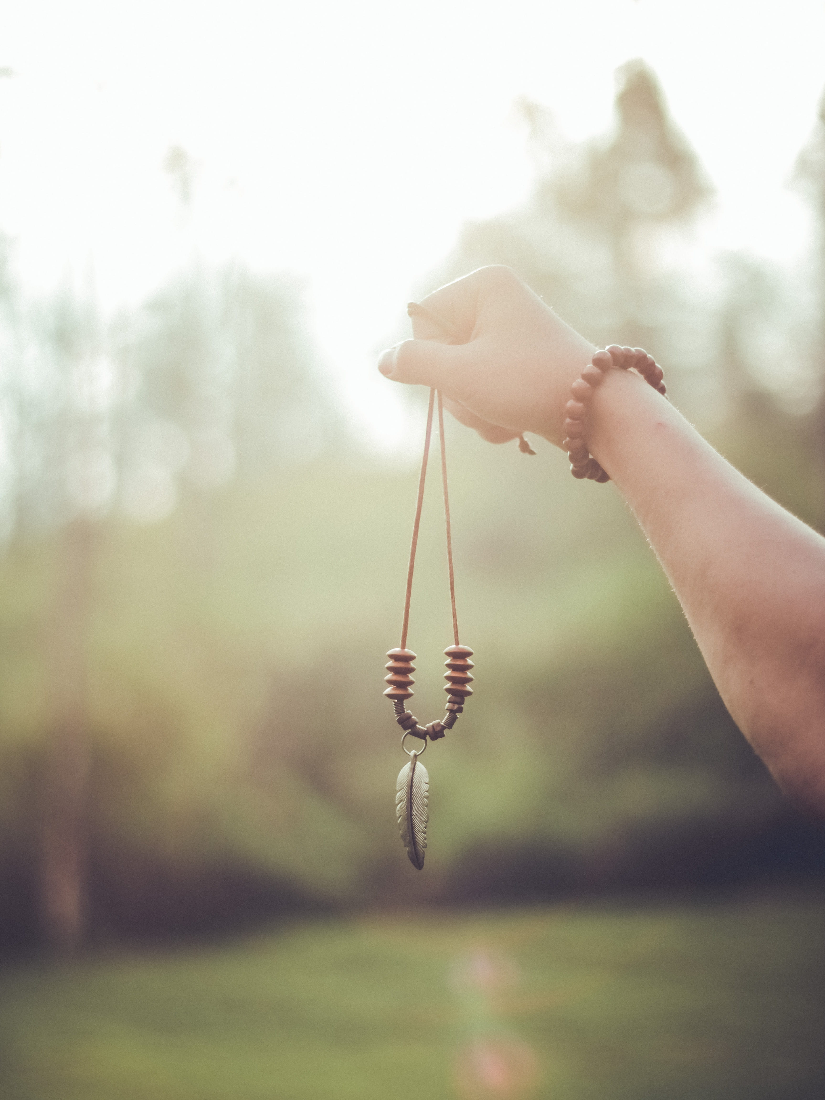 sun, hand, outdoors, men, jewelry, bandung, feather, close-up, morning, caucasian Ethnicity, females, human Hand, beaded, necklace, sunlight, rancaupa, Phone HD Wallpaper