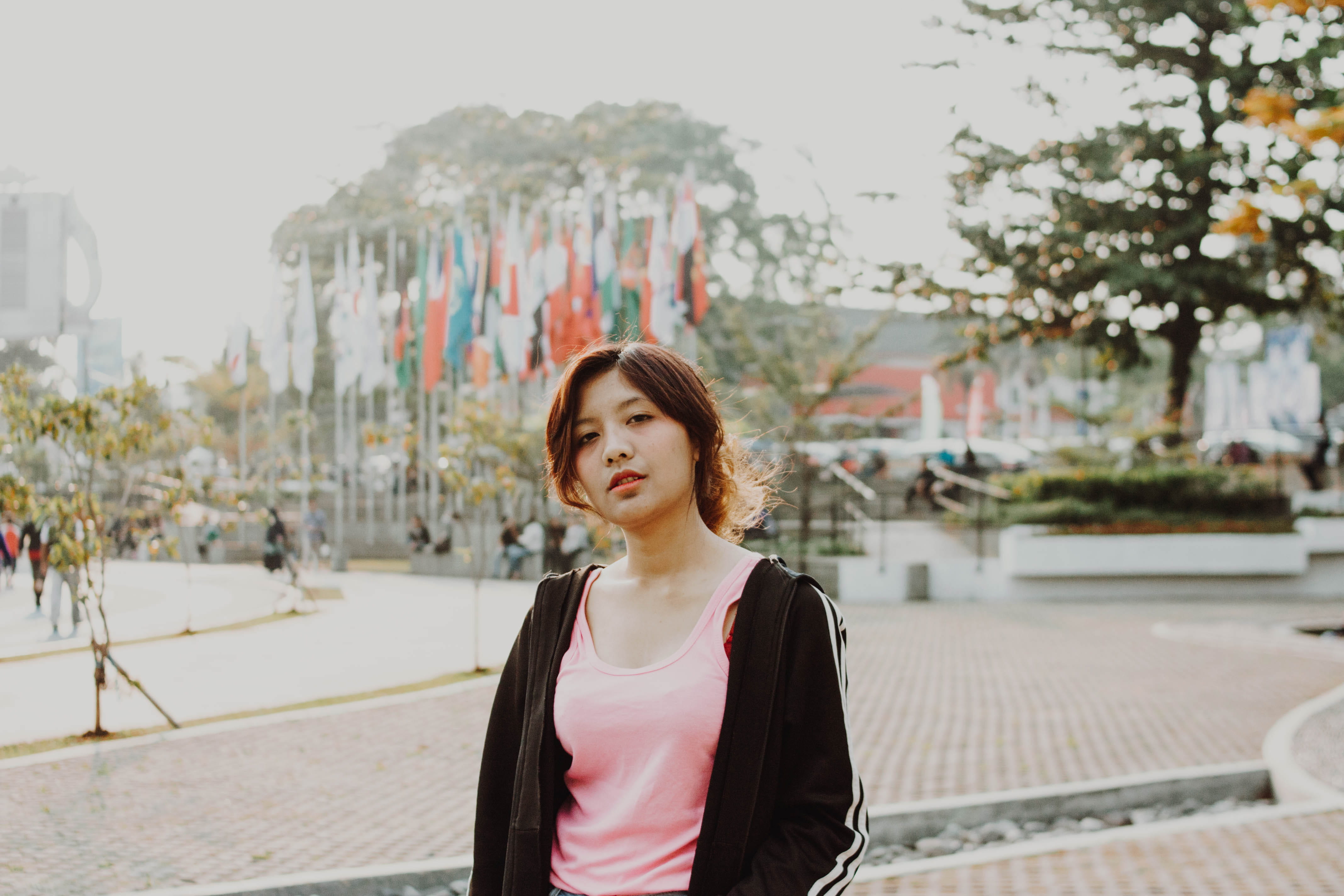 face, teenager, handrail, apparel, casual clothing, hairstyle, looking, young women, standing, flags, waist up, sleeve, focus on foreground, wearing, building exterior, HD Wallpaper