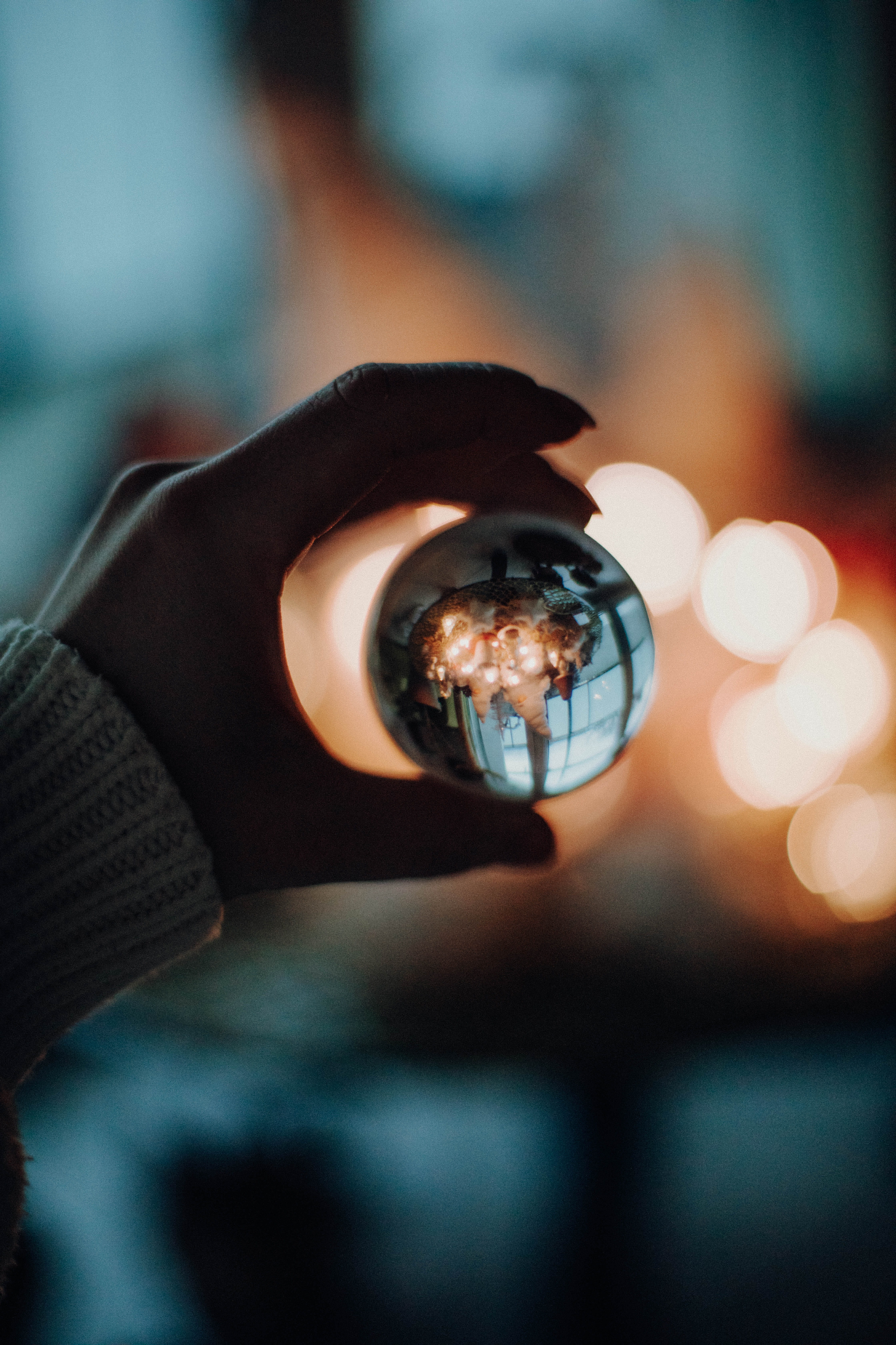 reflection, holding, fashion, day, glass, close-up, human limb, ball, outdoors, nature, person, lights, fingers, focus on foreground, real people, indoors, Phone HD Wallpaper