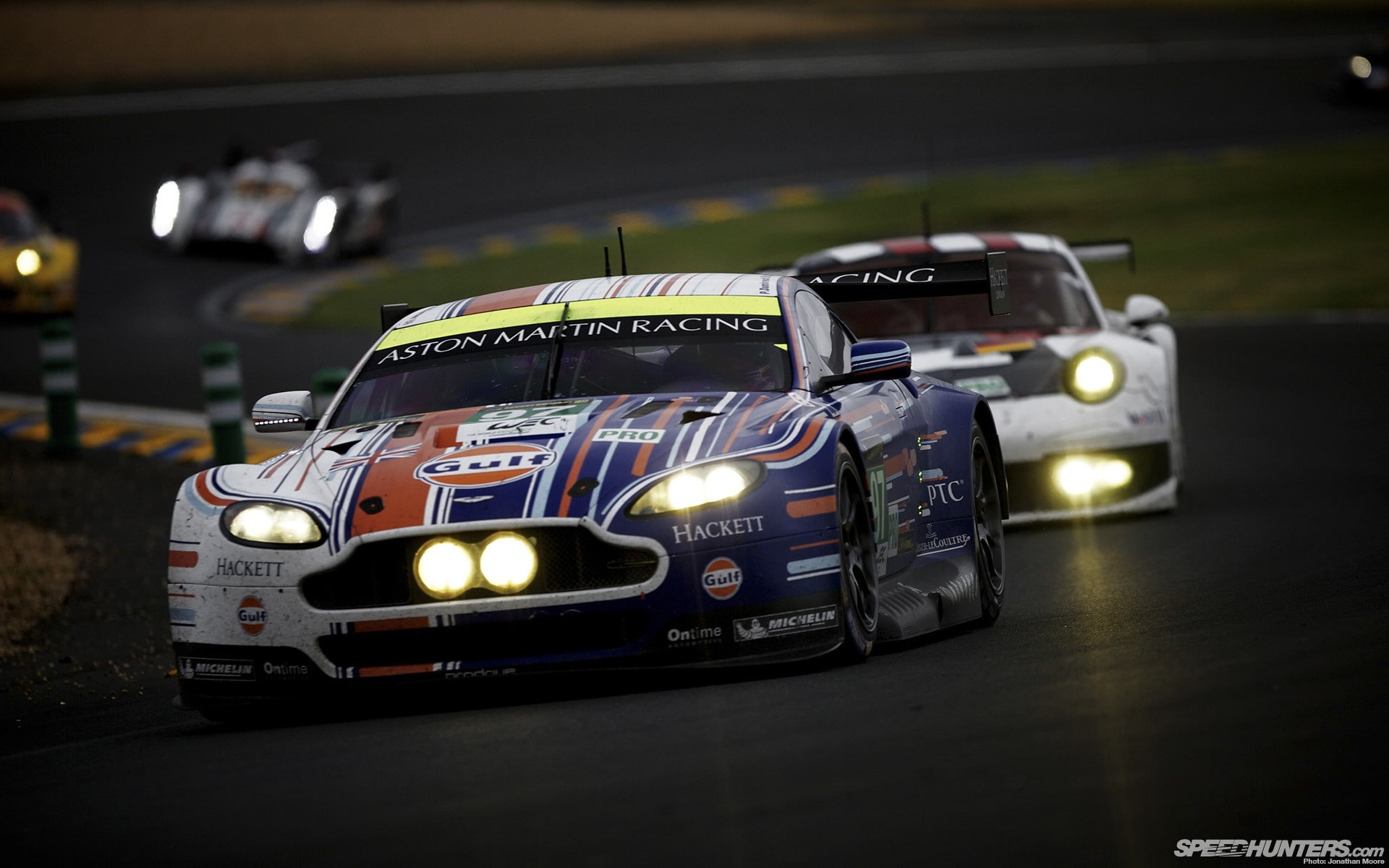 headlight, competition, indoors, race cars, 1080P, sport, land vehicle, focus on foreground, Aston Martin, auto racing, night, professional sport, text, HD Wallpaper