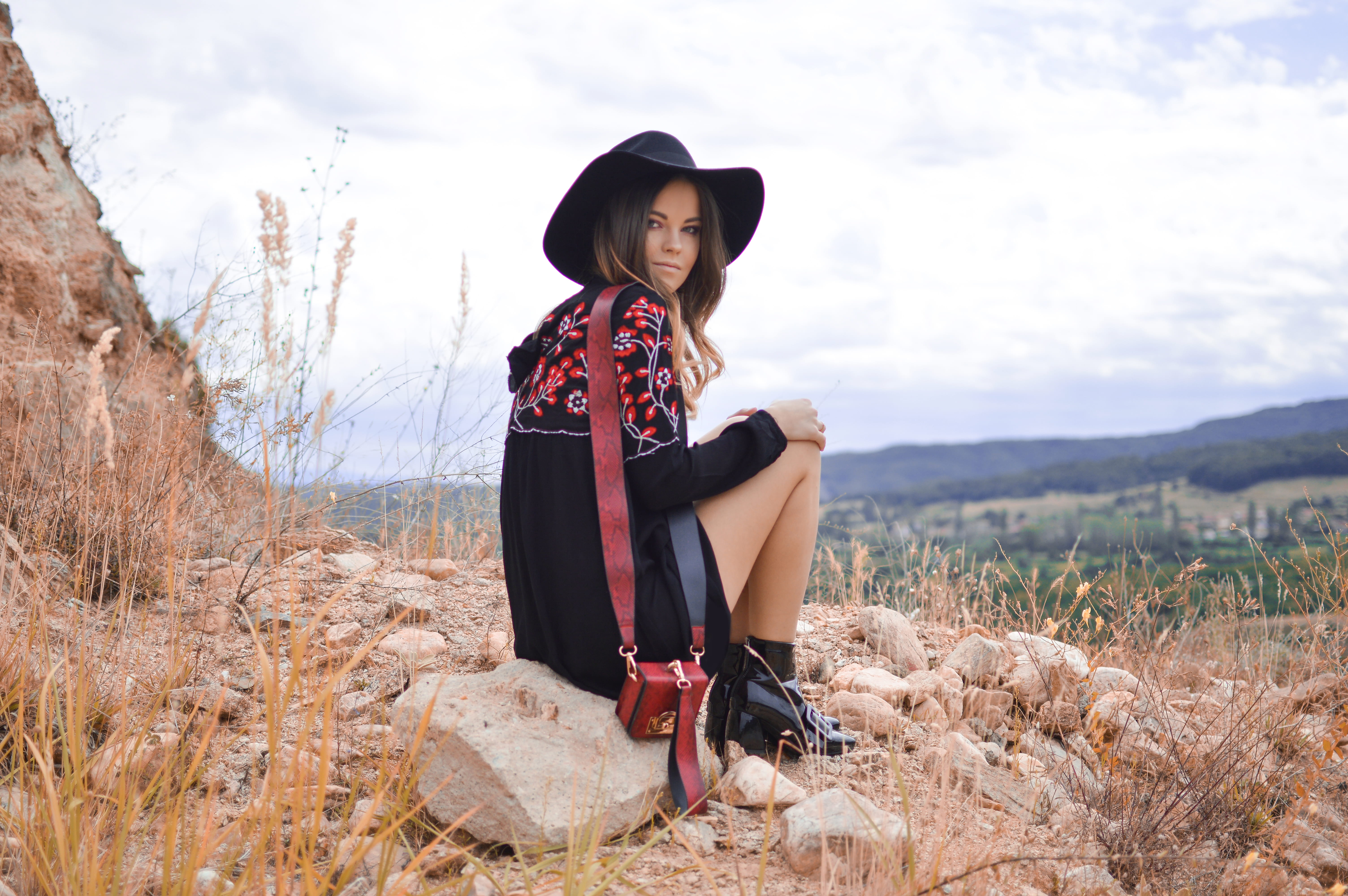bag, one person, young women, woman, sitting, sky, fashion, field, full length, black, rock, 5K, near, girl, lady, women, brunette, young adult, countryside, HD Wallpaper
