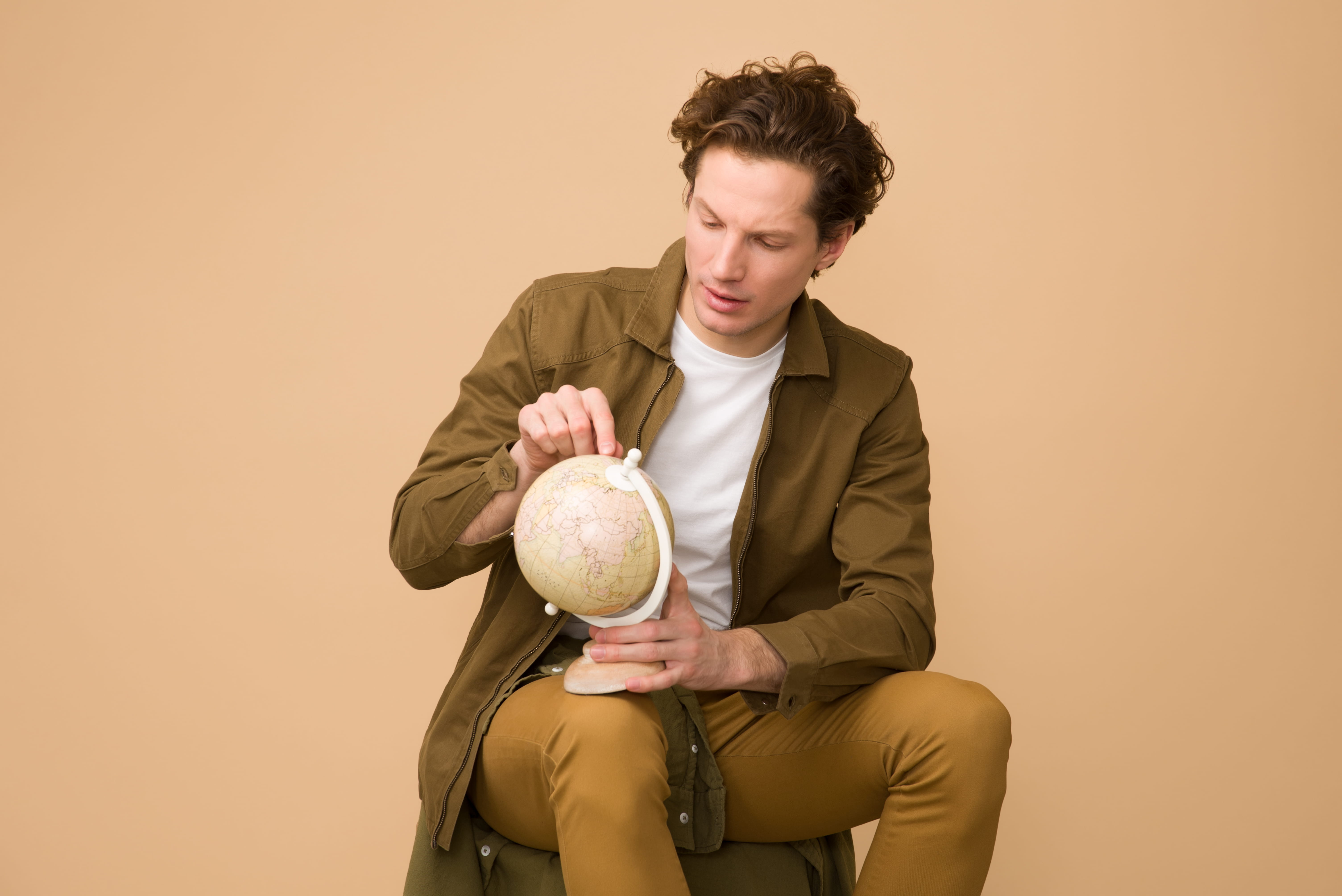man, relocation, front view, camel color, sport, males, holding, well-dressed, sit, vacation, earth globe, holiday, male, young man, 5K, three quarter length, HD Wallpaper