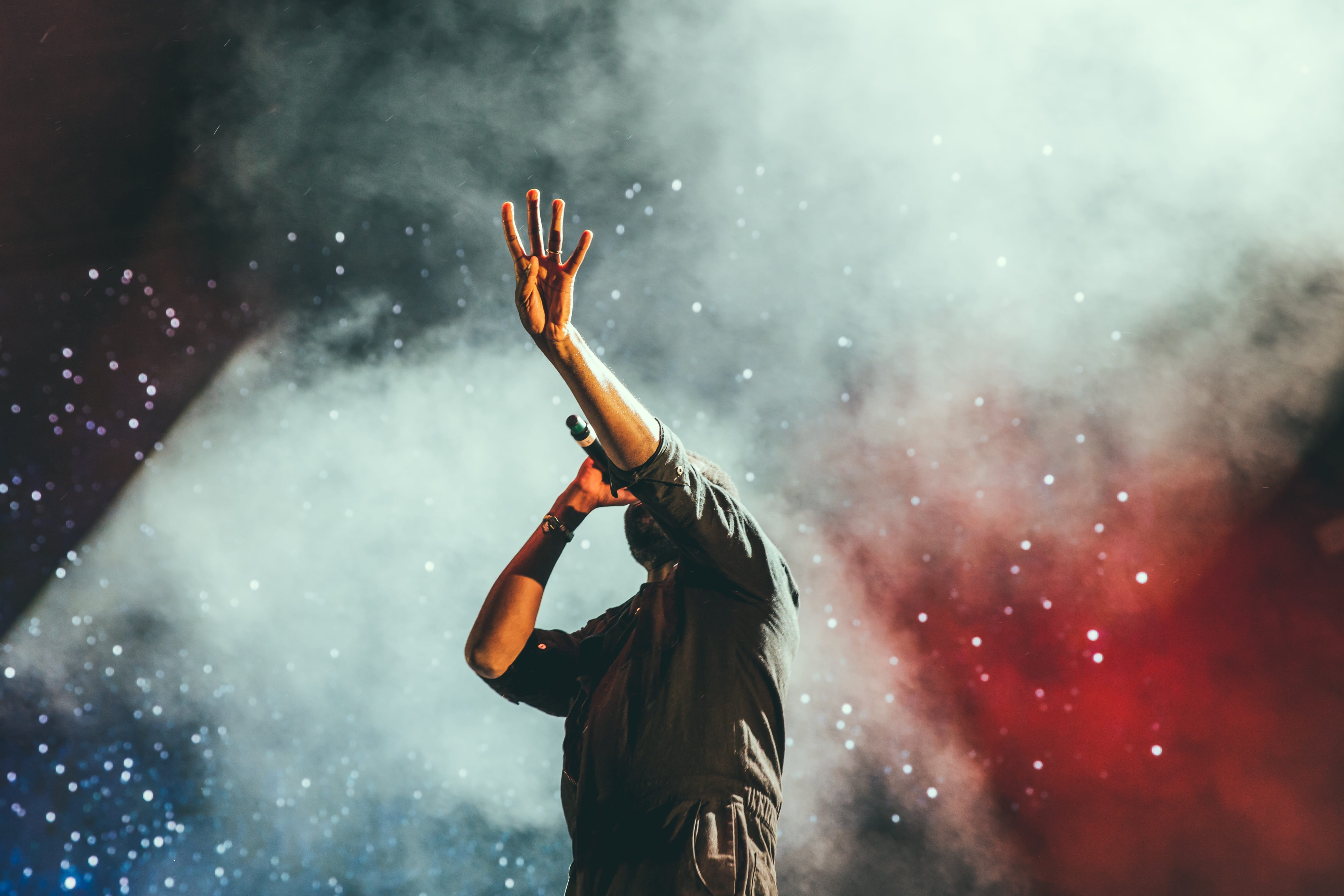leisure activity, one person, hand raised, music festival, smoke, rear view, festival, music, smoke - physical structure, women, waist up, concert, spotlight, HD Wallpaper