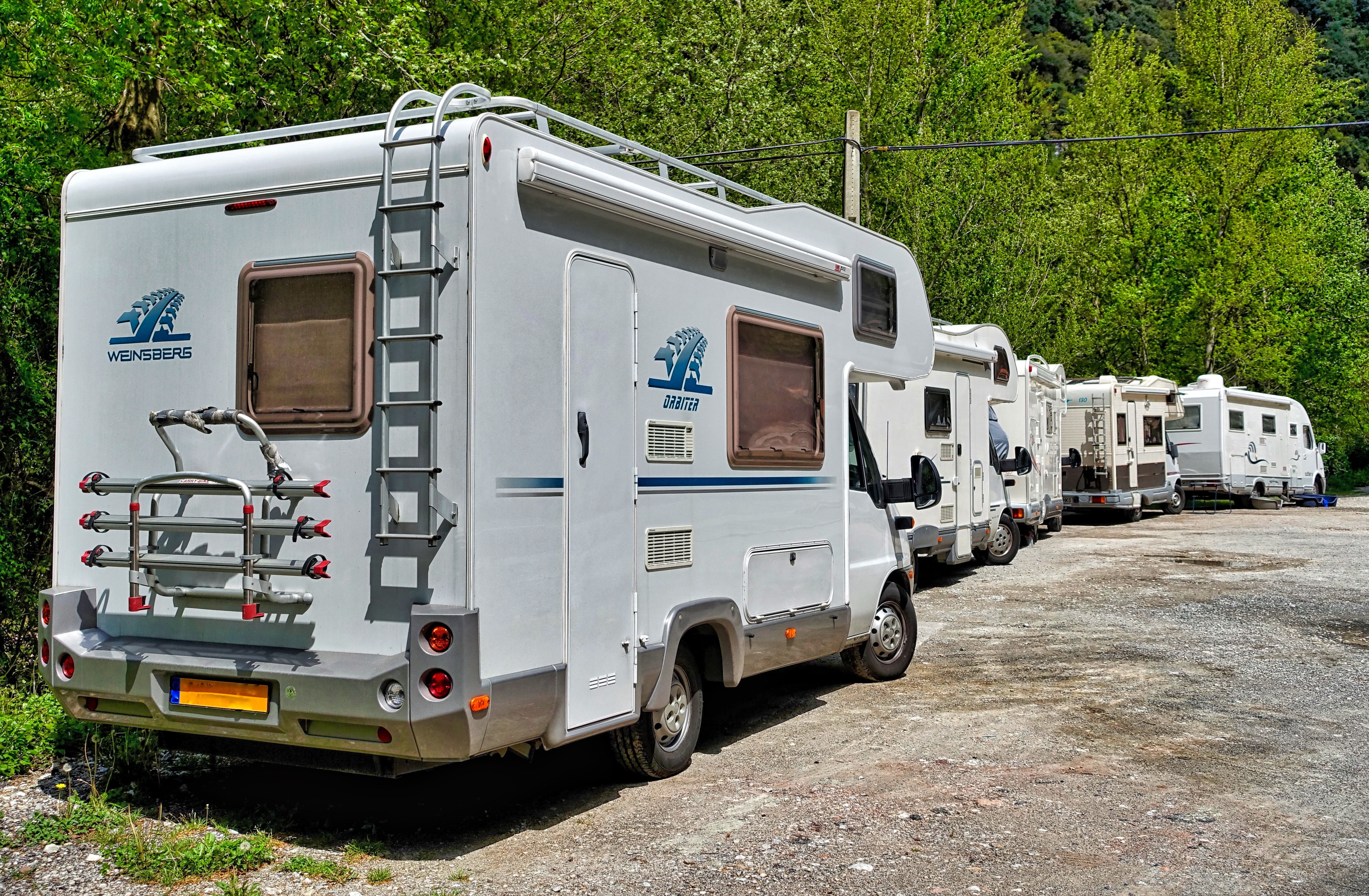 motor home, vehicle, truck, lot, plant, transport, day, Campers, built structure, stationary, city, white, travel, tree, accidents and disasters, no people, HD Wallpaper