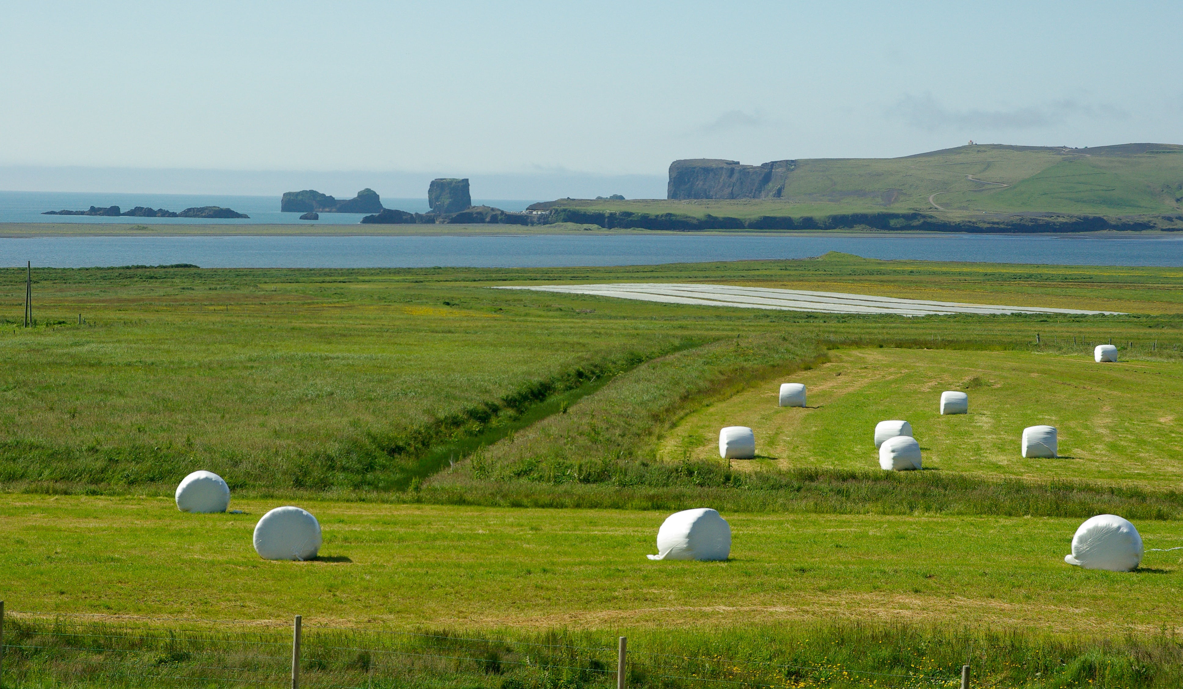 land, bale, sky, tranquil scene, cliffs, plant, green color, 4K, landscape, nature, iceland, meadow, outdoors, grass, no people, non-urban scene, agriculture, HD Wallpaper