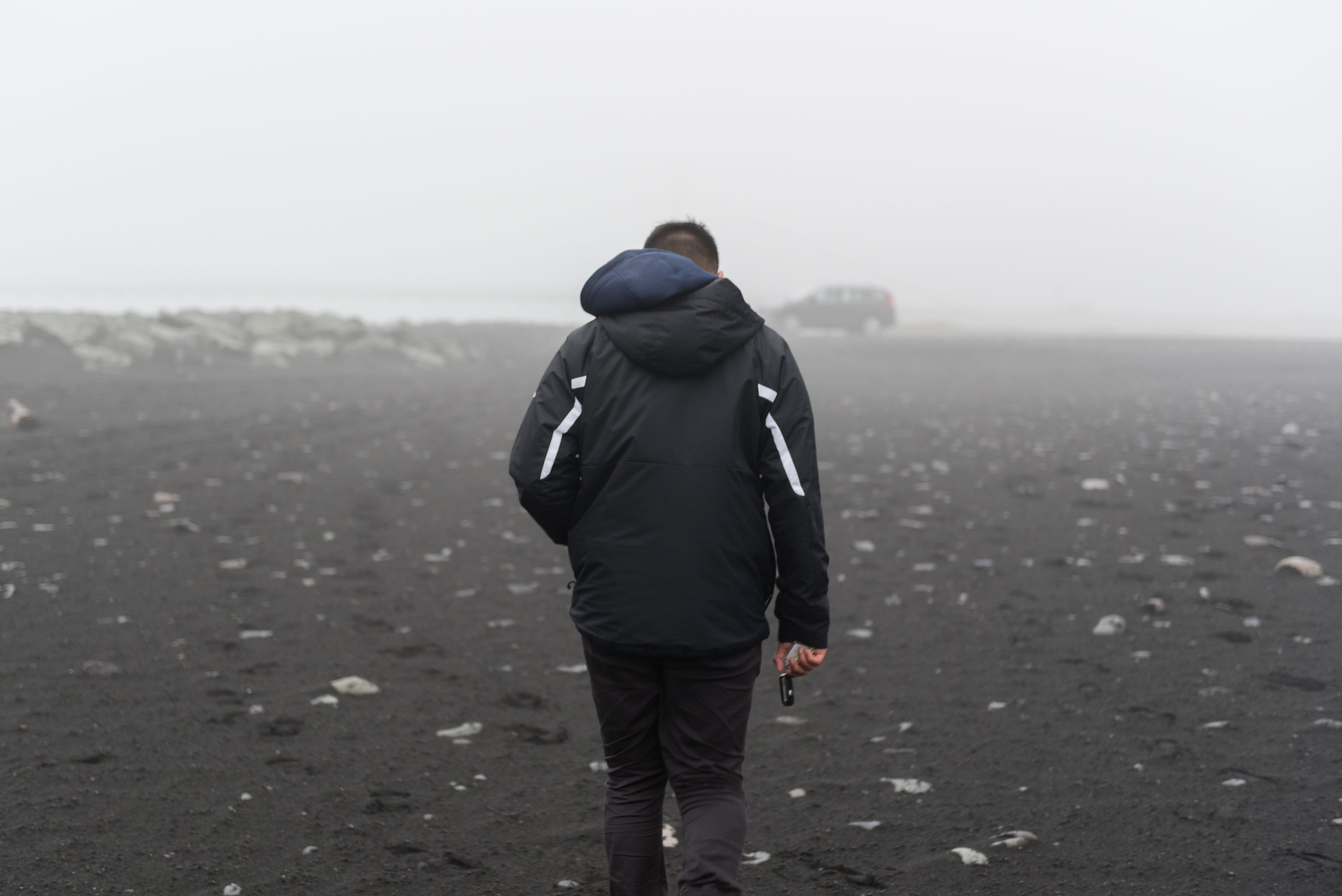 rain, fog, sand, standing, 5K, hood - clothing, sky, land, vik, scenics - nature, day, beach, casual clothing, real people, full length, beauty in nature, HD Wallpaper