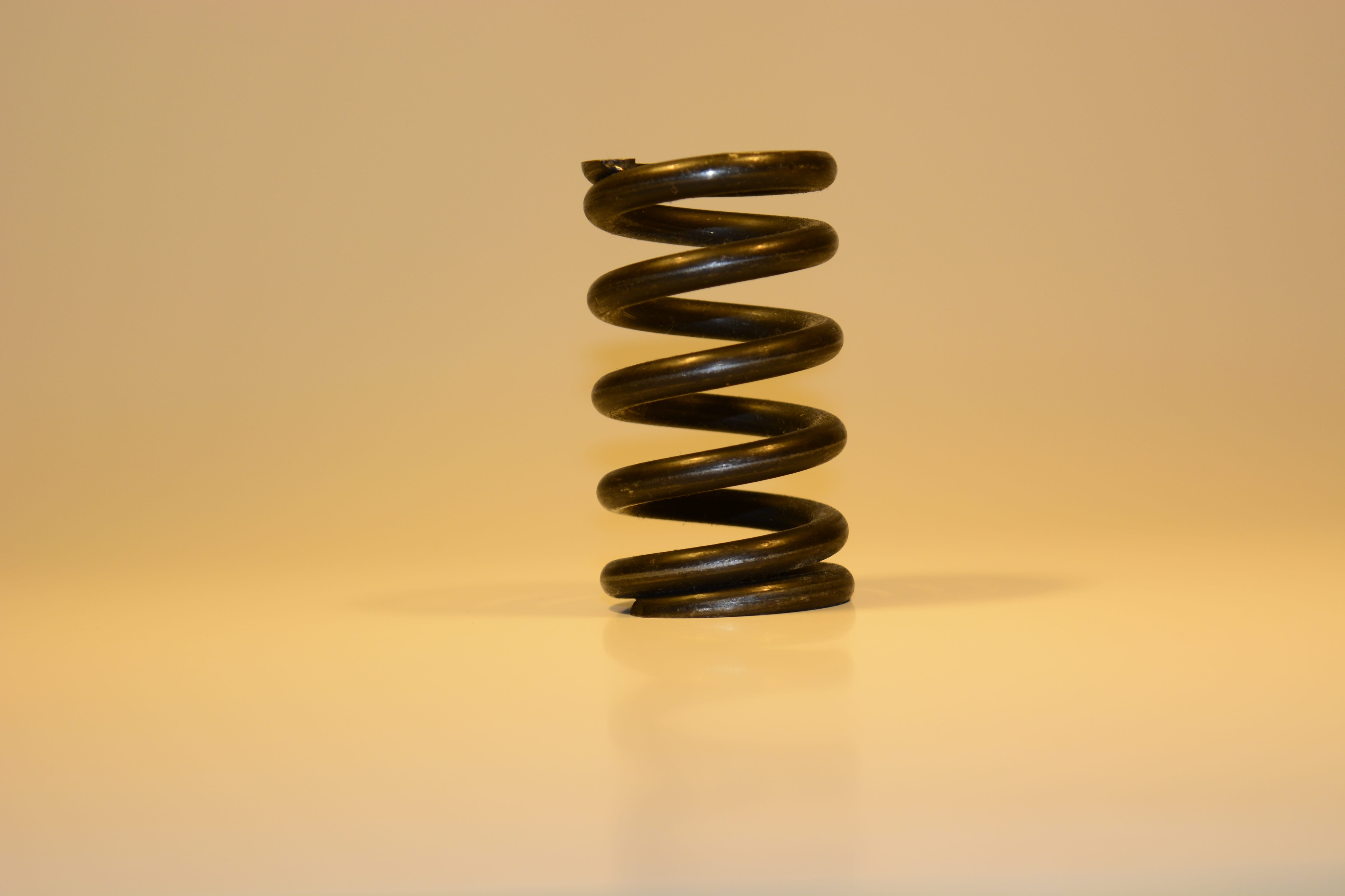 metal, 5K, black, colored background, yellow background, conceptual, close-up, blur, focus, studio shot, coil, no people, beige background, indoors, single object, HD Wallpaper