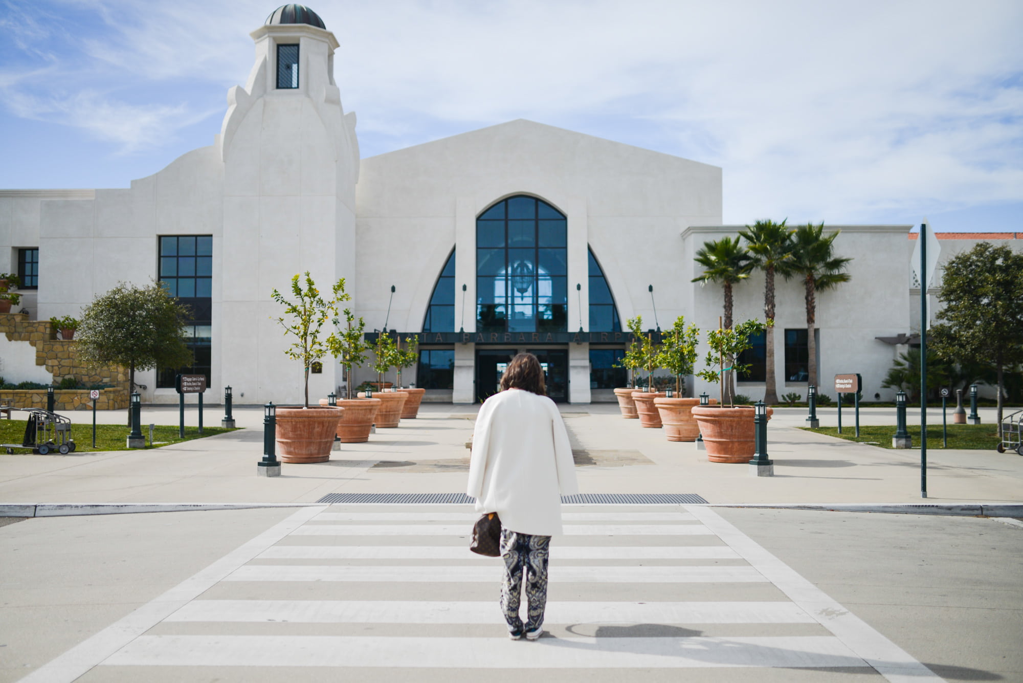 street, top, coat, palm trees, airport, one person, pedestrian, full length, woman, built structure, belief, sidewalk, plants, lifestyles, jacket, women, HD Wallpaper