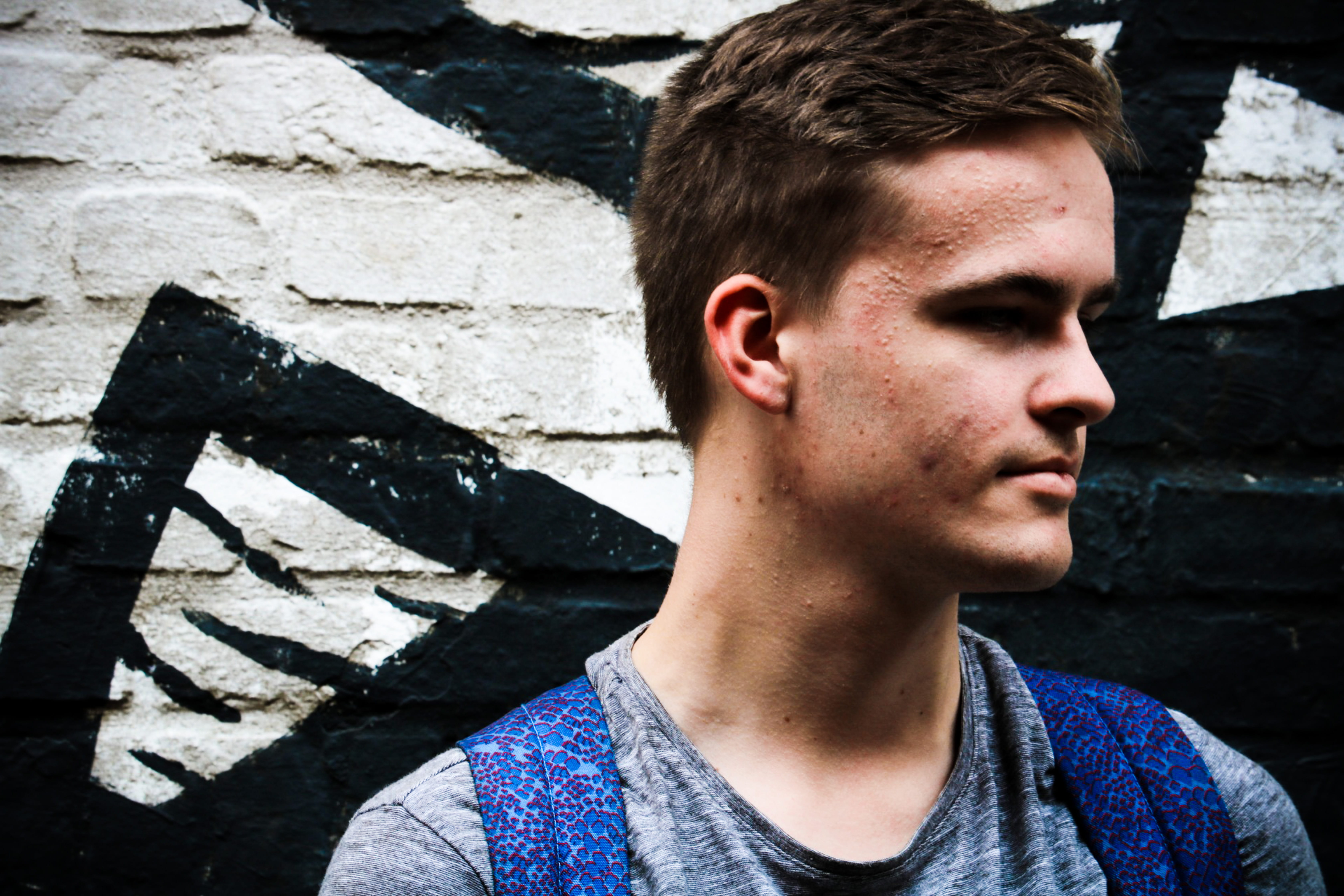 front view, adolescence, nose, distracted, casual clothing, netherlands, outdoors, one person, contemplation, lifestyles, young men, built structure, wall, HD Wallpaper