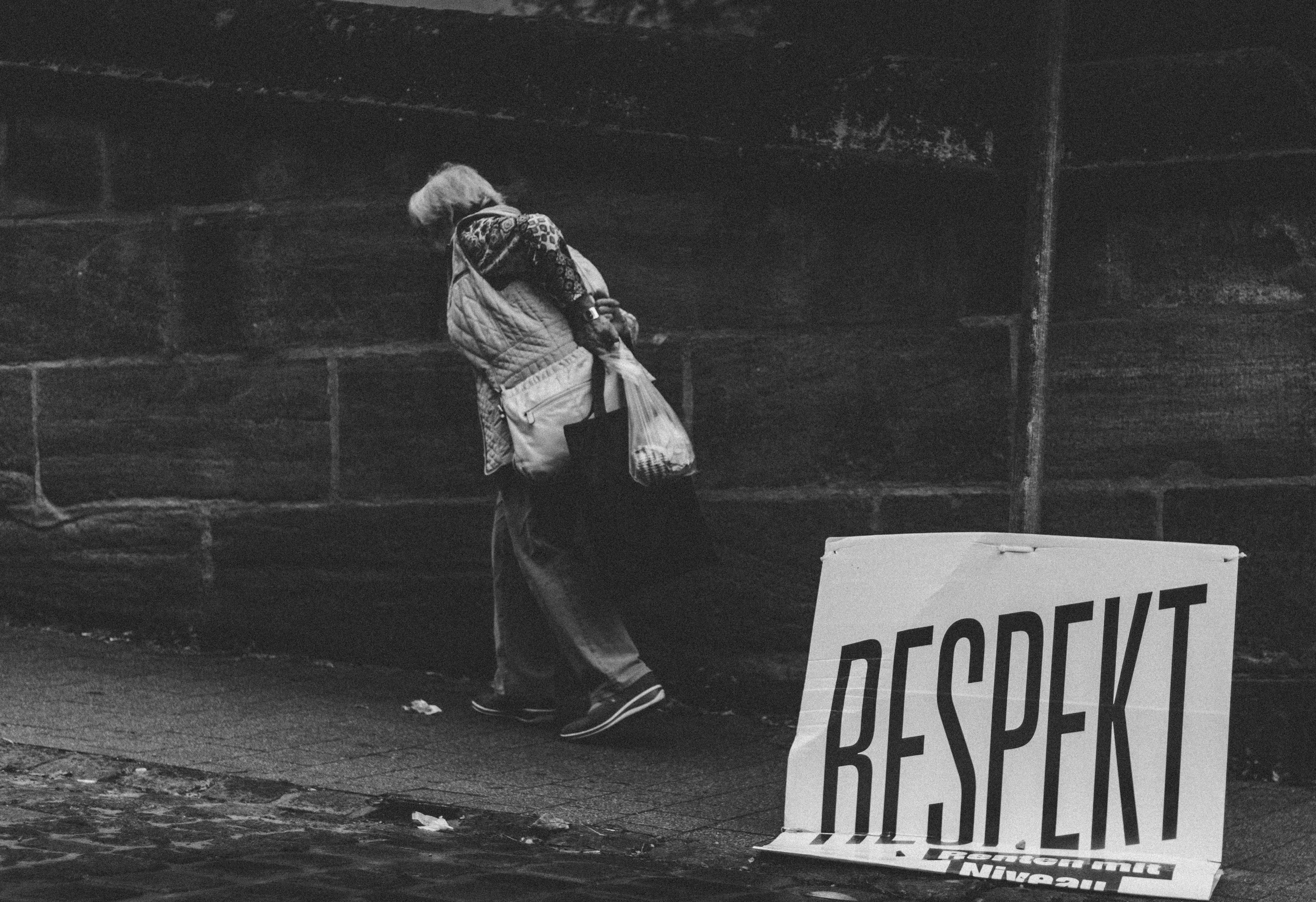 walking, casual clothing, outdoors, black and white, holding, bag, old, poster, plastic, capital letter, wall, real people, text, footpath, white, person, HD Wallpaper
