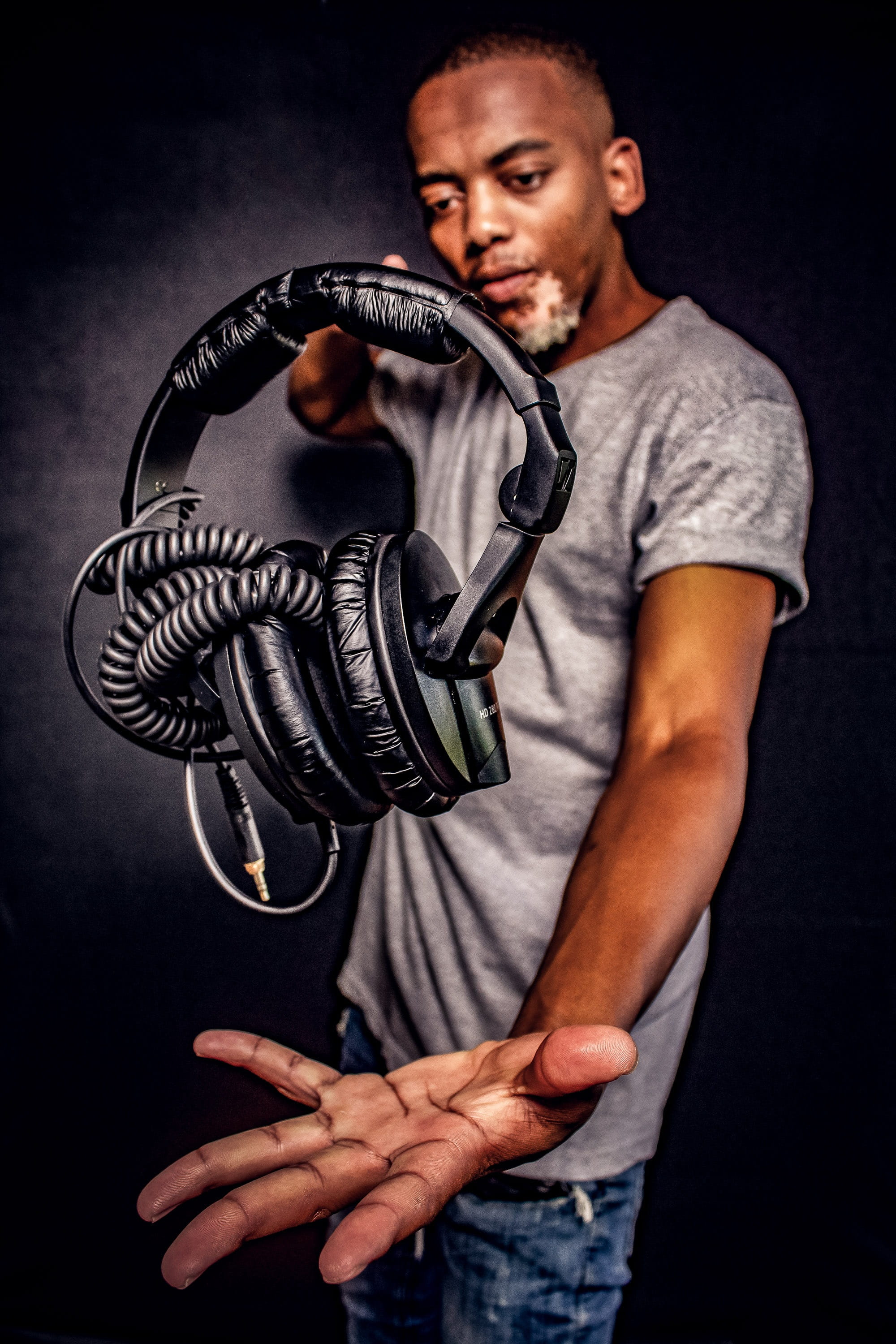 magic, human body part, studio shot, one person, black background, adult, black, young men, creative, indoors, hand, waist up, headphones, producer, casual clothing, Phone HD Wallpaper