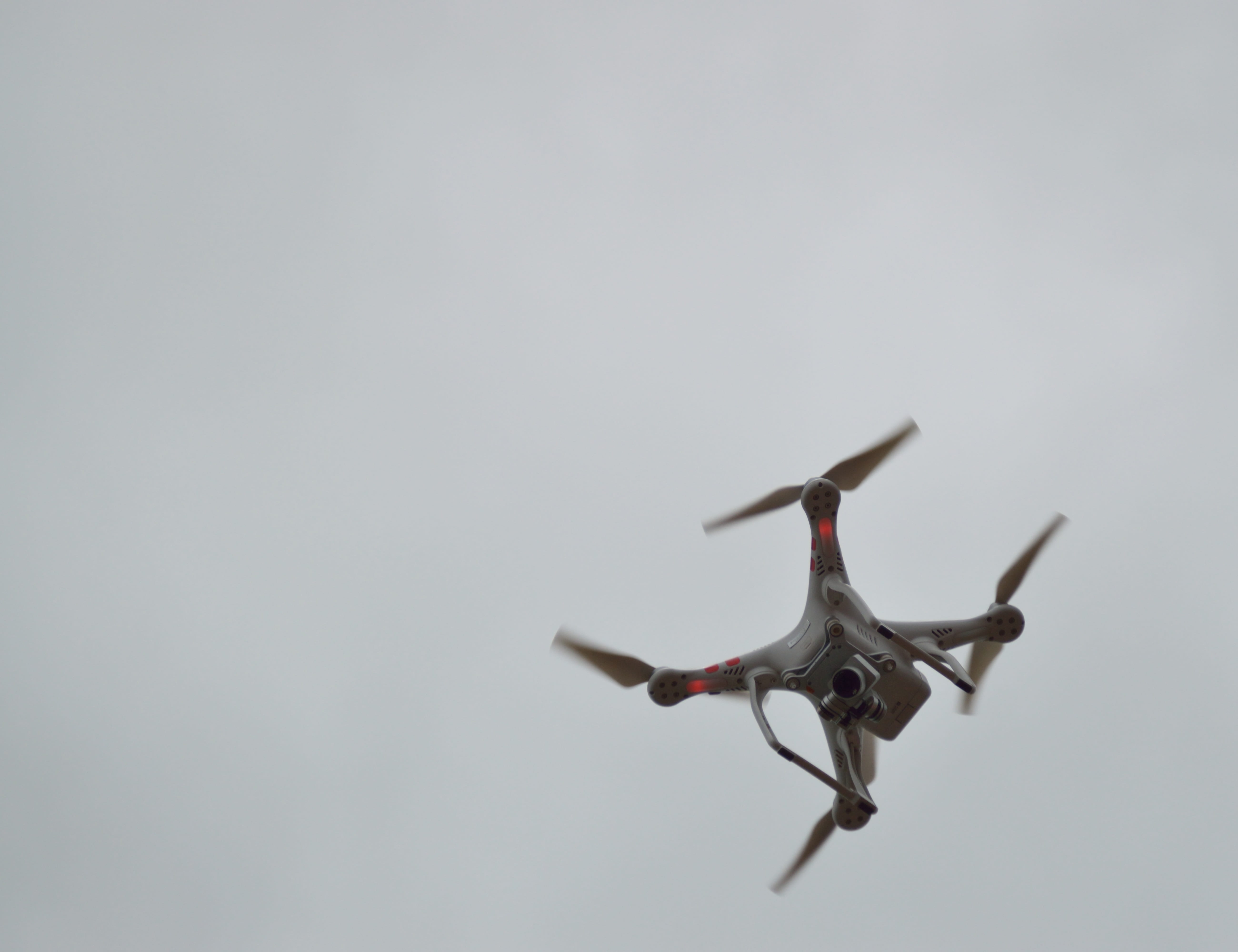 sky, gray background, motion, aggression, drone, air, air vehicle, camera, helicopter, vehicle, propellers, spy, lens, surveillance, side view, gray, technology, HD Wallpaper