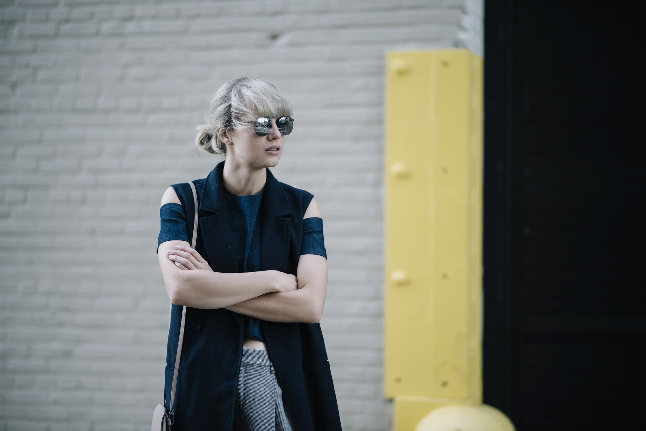 real people, glasses, fashion, leisure activity, hairstyle, standing, bangs, three quarter length, brick, beautiful woman, day, 1080P, contemplation, casual clothing, HD Wallpaper