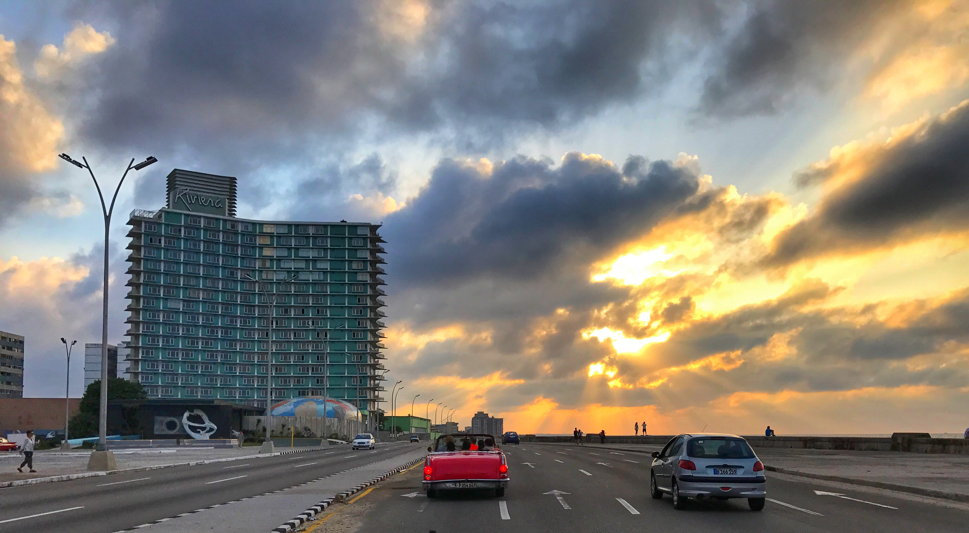 motor vehicle, malecón habanero, nature, 2K, building, multiple lane highway, skyscraper, sign, cloud - sky, office building exterior, road, sunset, mode of transportation, HD Wallpaper