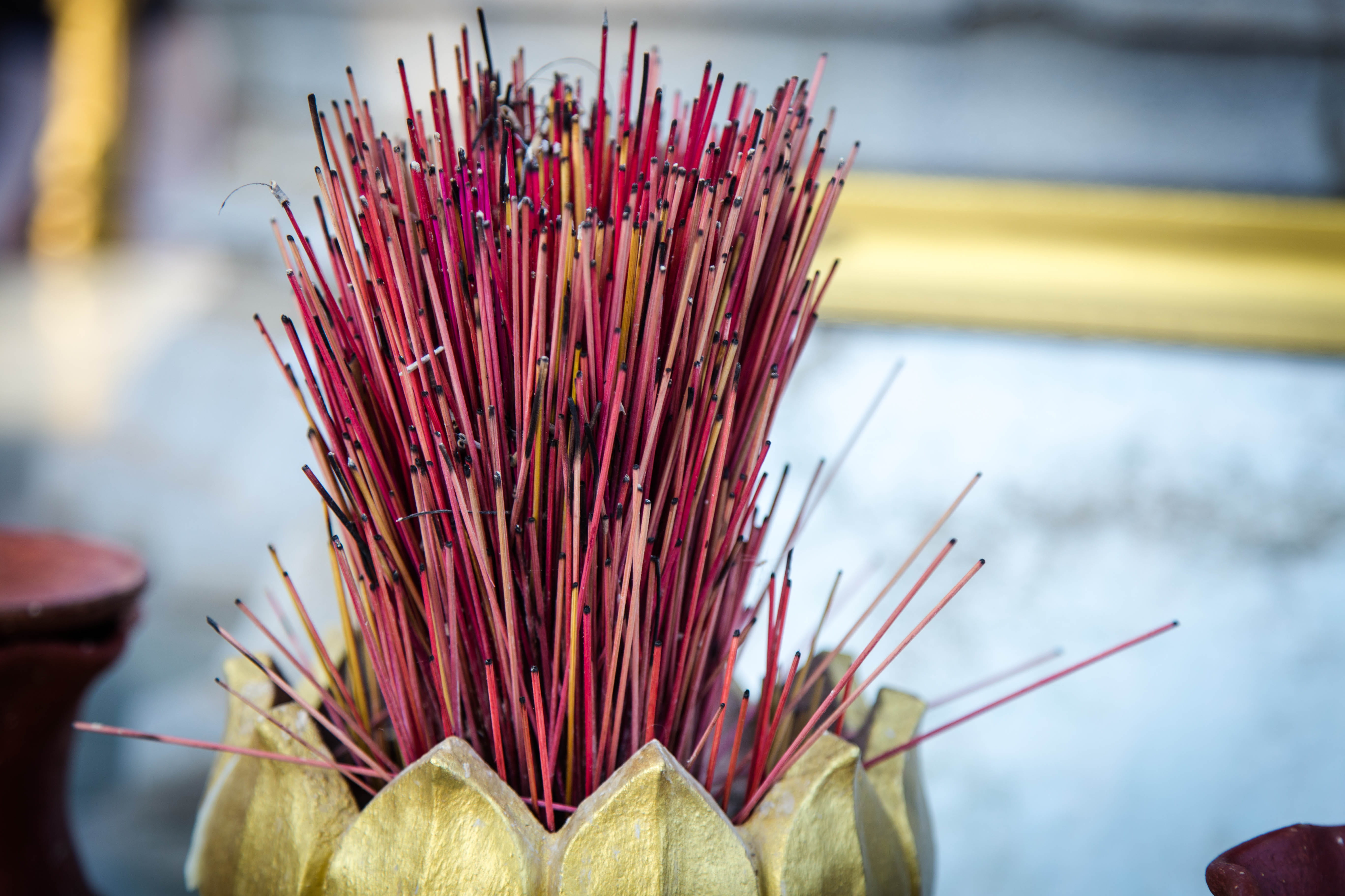 belief, large group of objects, yellow, phnom penh, close-up, incense, indoors, buddism, building, cambodia, selective focus, stick - plant part, built structure, HD Wallpaper