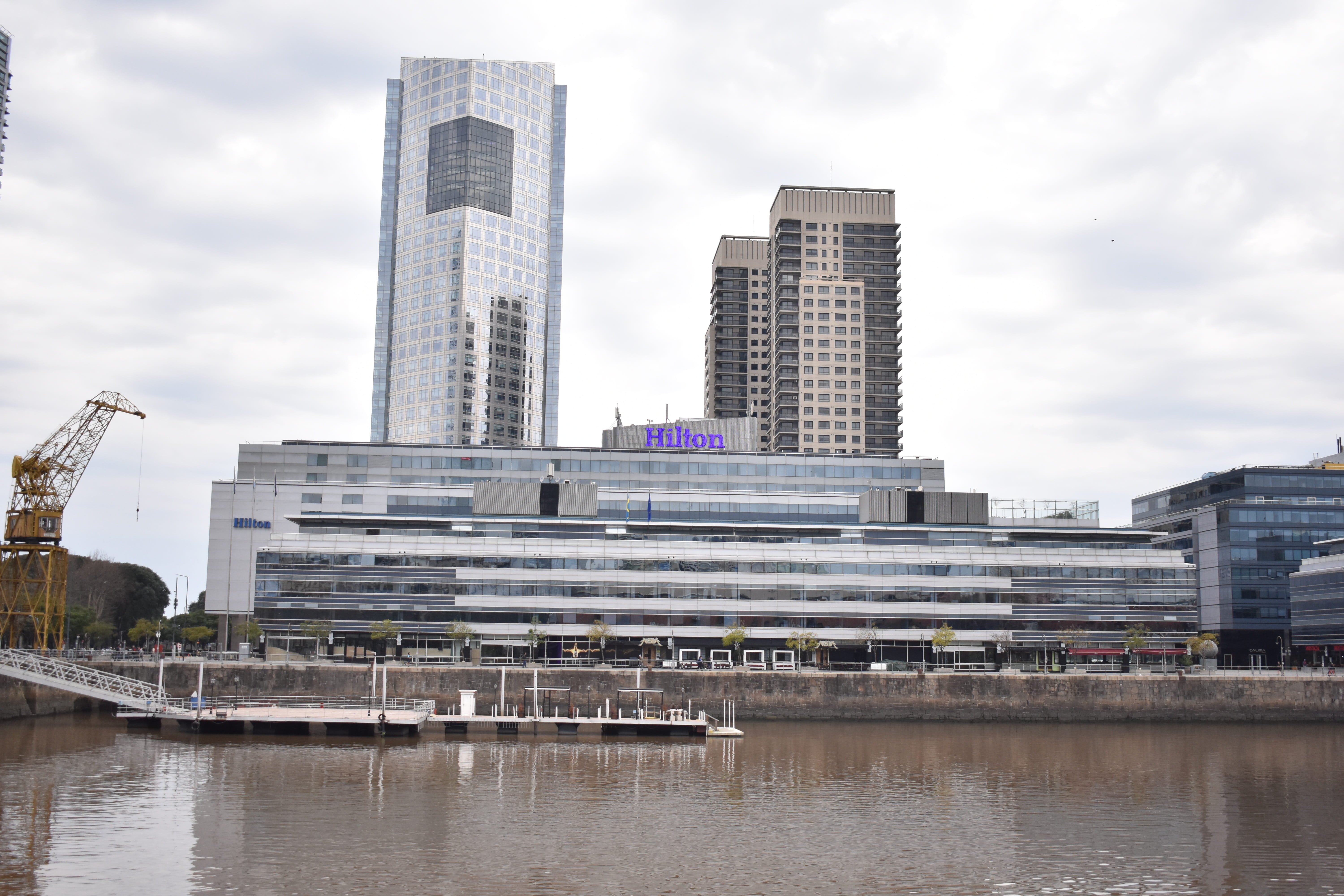 waterfront, reflection, outdoors, hotels, horizon, boat, no people, nature, architecture, city, building, port, day, tall - high, spring, modern, cloud - sky, HD Wallpaper