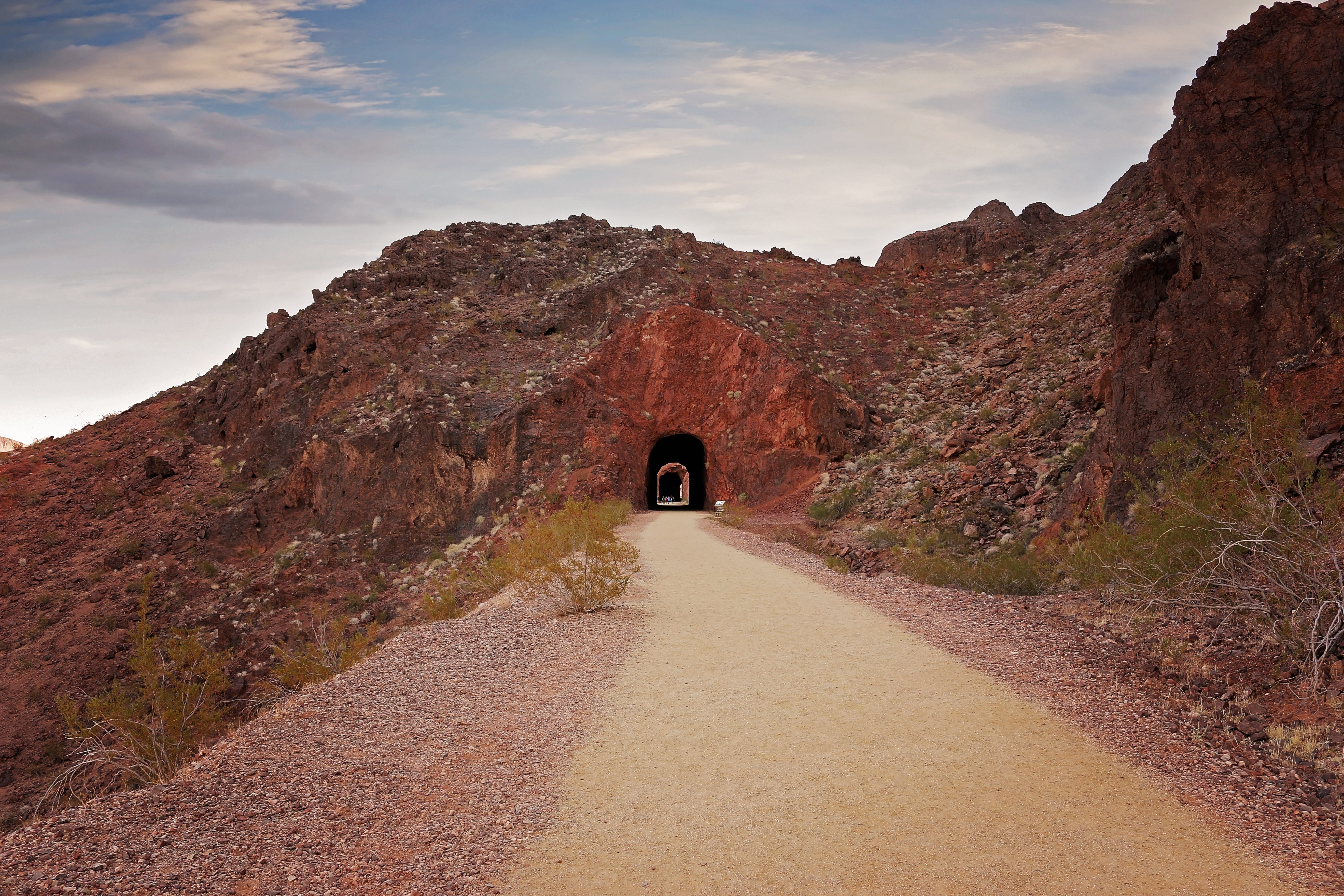 outdoors, cloud - sky, sky, desert, rock formation, travel, road, rock, bridge, one person, scenic, rear view, tunnel, mountain, wonder, nature, railroad trail, HD Wallpaper