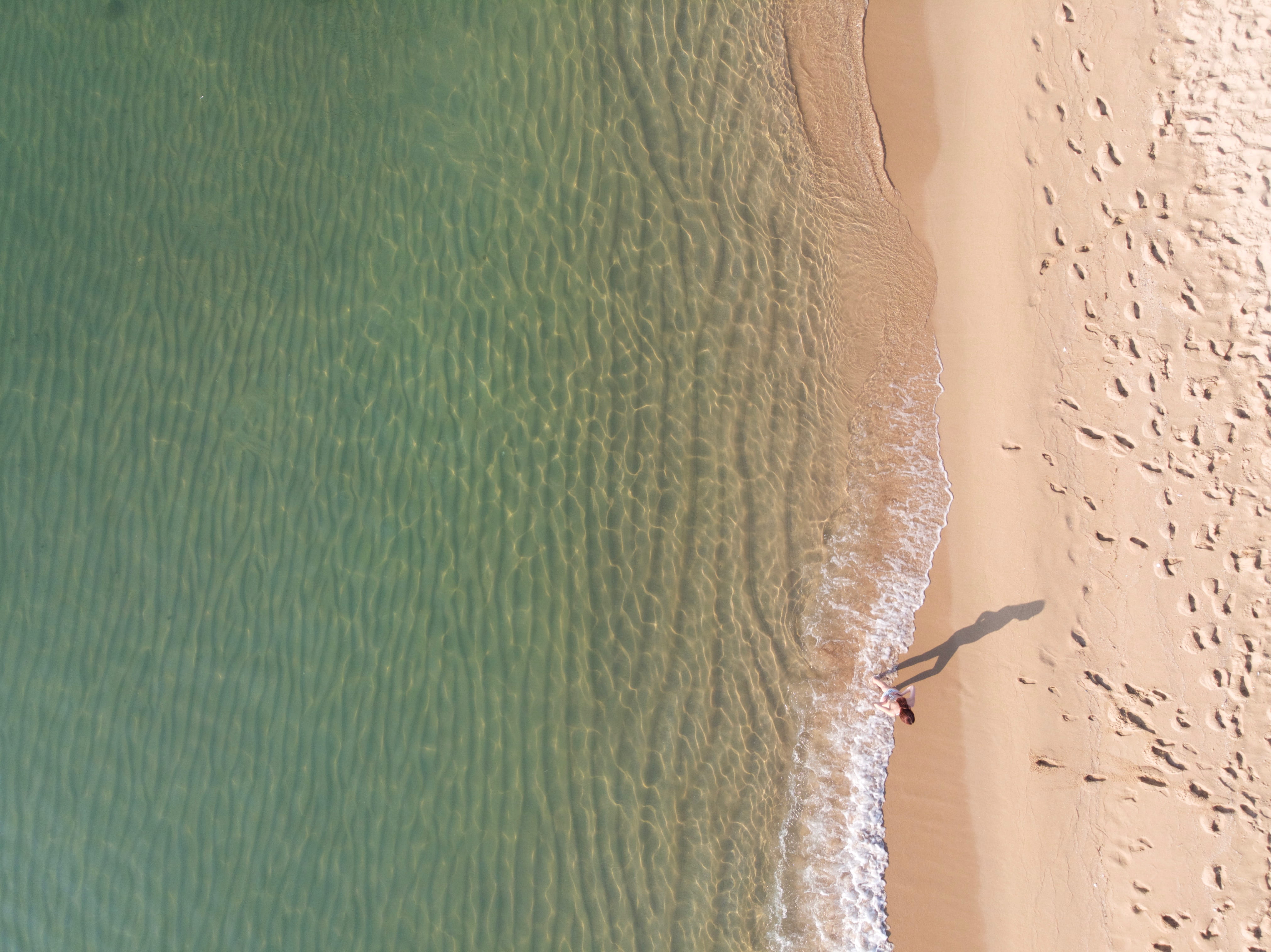 near, drone photography, walking, shore, outdoors, beach, travel destinations, standing, beauty in nature, person, high angle view, water, HD Wallpaper