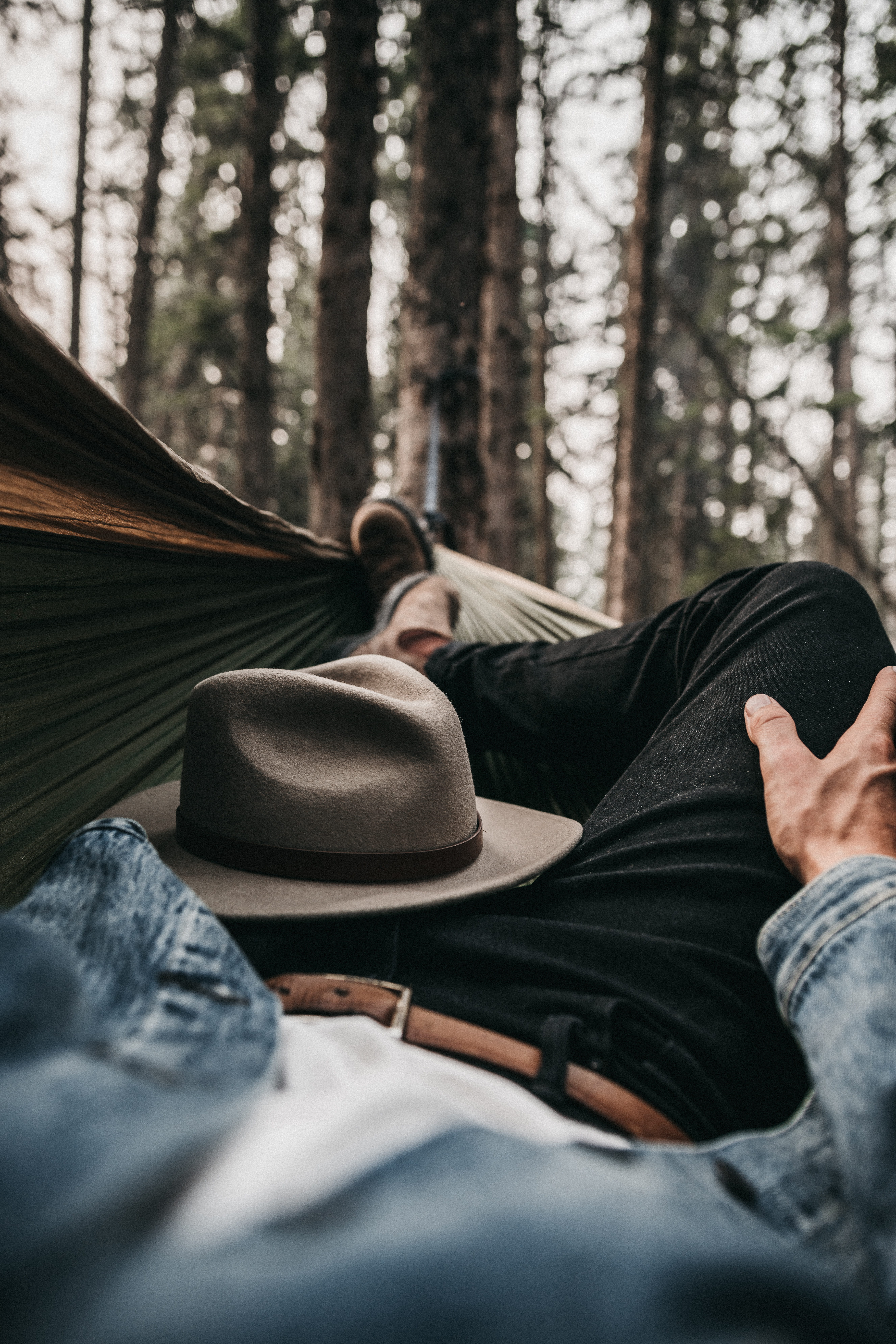 relaxation, woodland, wood, outdoors, pine tree, forest, real people, low section, land, resting, lifestyles, hammock, one person, solitude, relax, hat, Phone HD Wallpaper