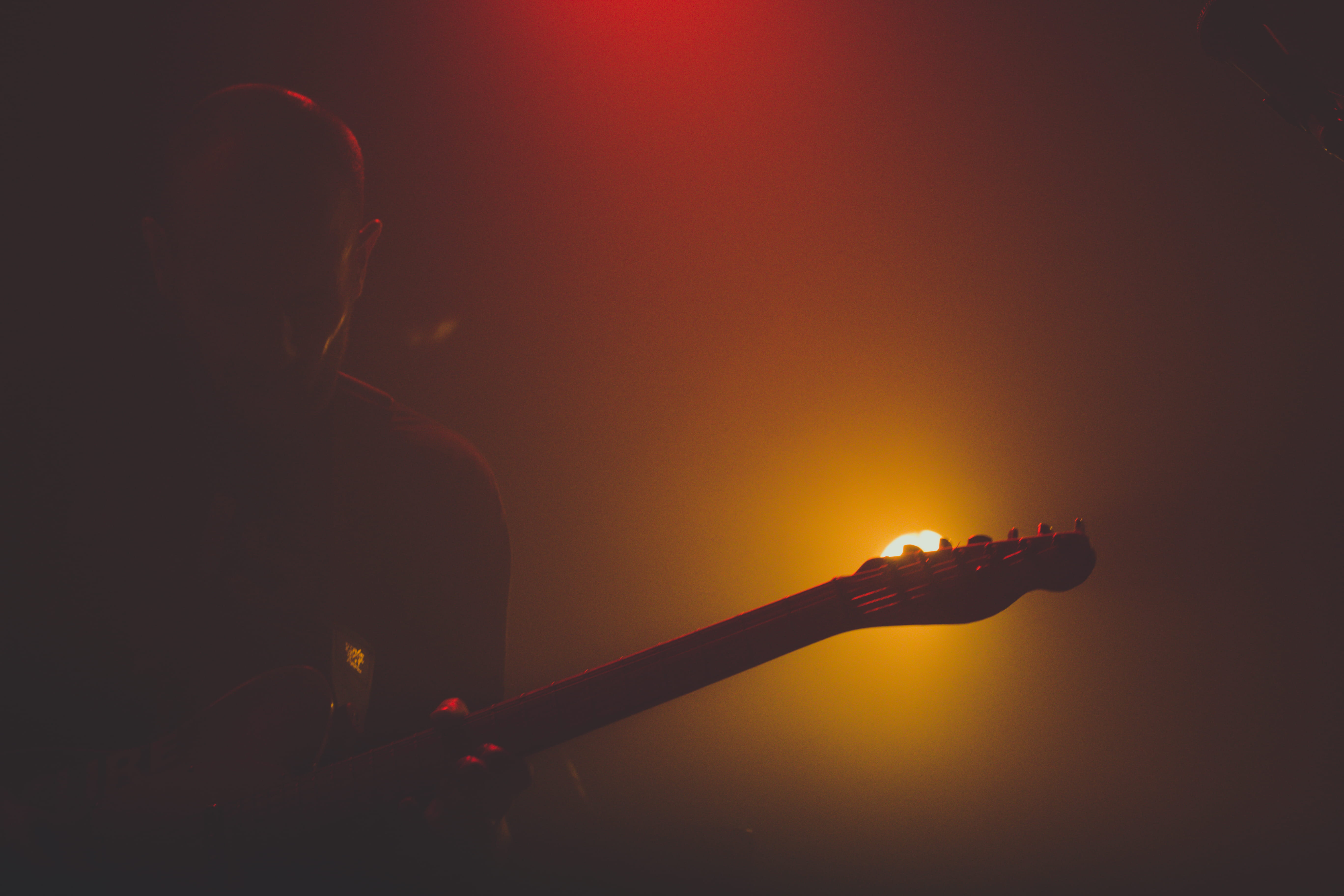 wolverton, fender, gig, 5K, enjoyment, red, united kingdom, guitar, indoors, performance, illuminated, orange, silhouette, fire, and so i watch you from afar, HD Wallpaper
