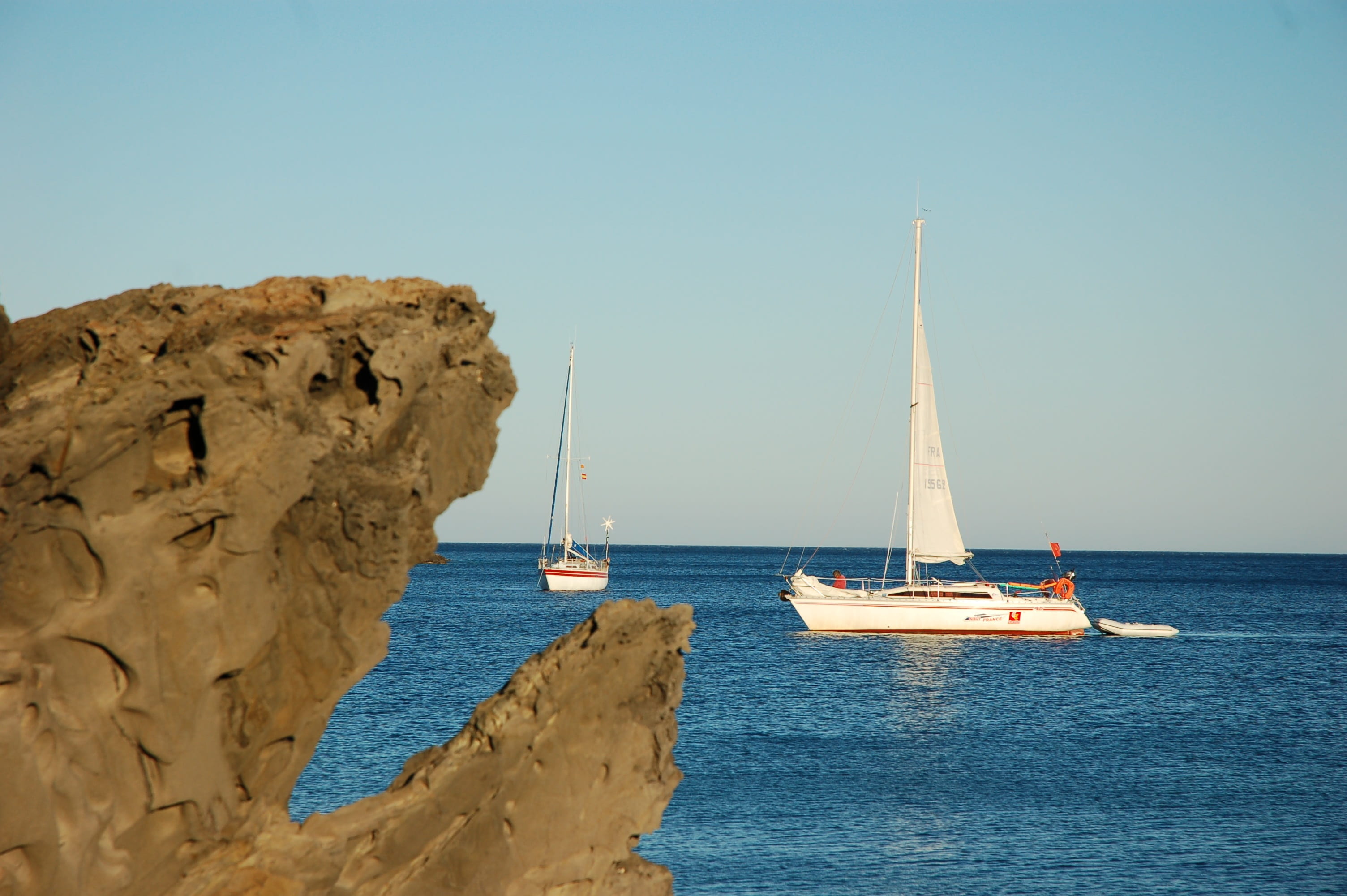 beauty in nature, rock - object, day, outdoors, no people, nature, 2K, yacht, sea, sky, nautical vessel, transportation, solid, boat, cadaqués, clear sky, HD Wallpaper