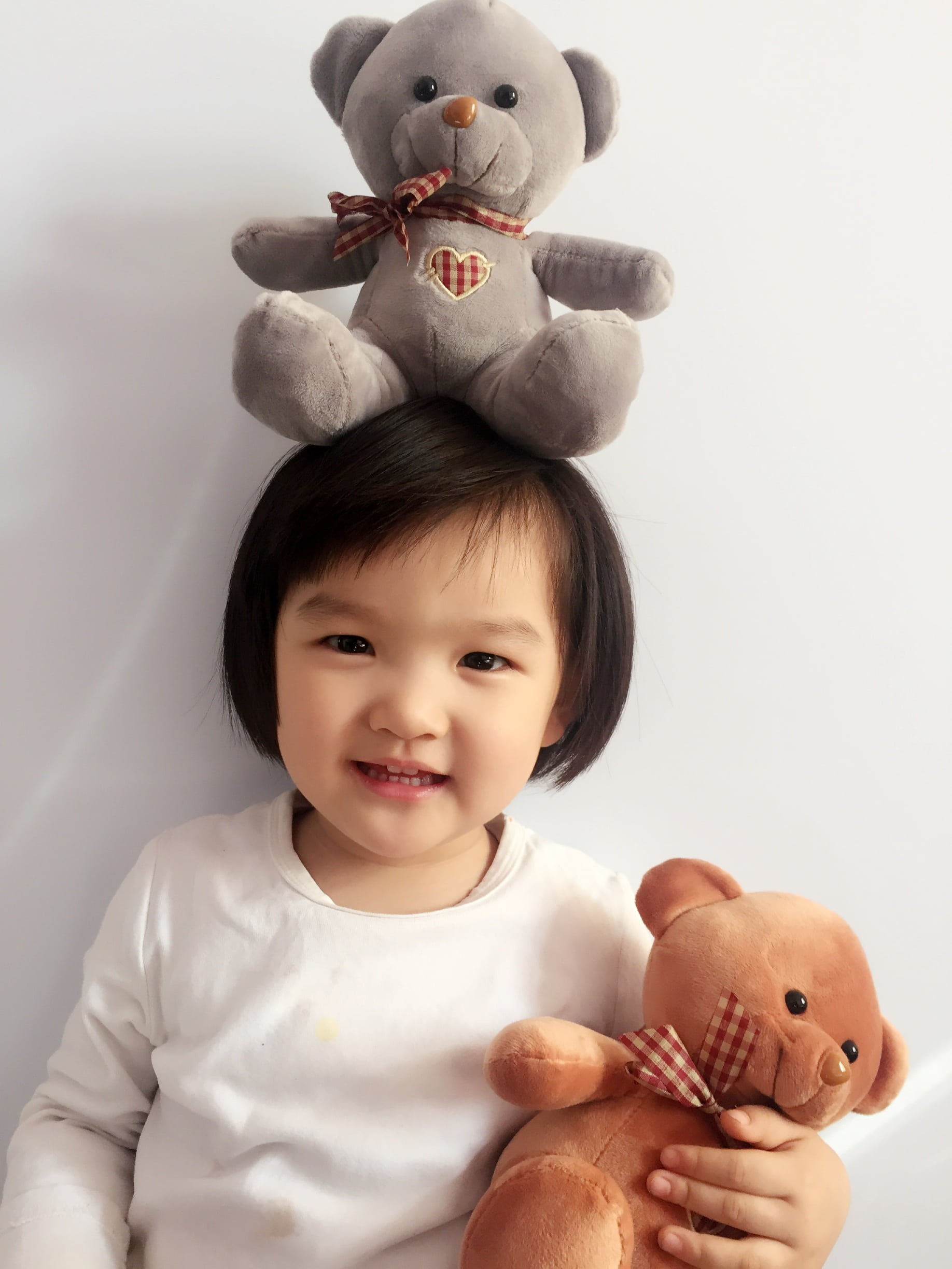 stuffed toy, girl, holding, smiling, 1080P, indoors, bear, real people, studio shot, looking at camera, cute, childhood, teddy bear, toy, one person, brown, Phone HD Wallpaper