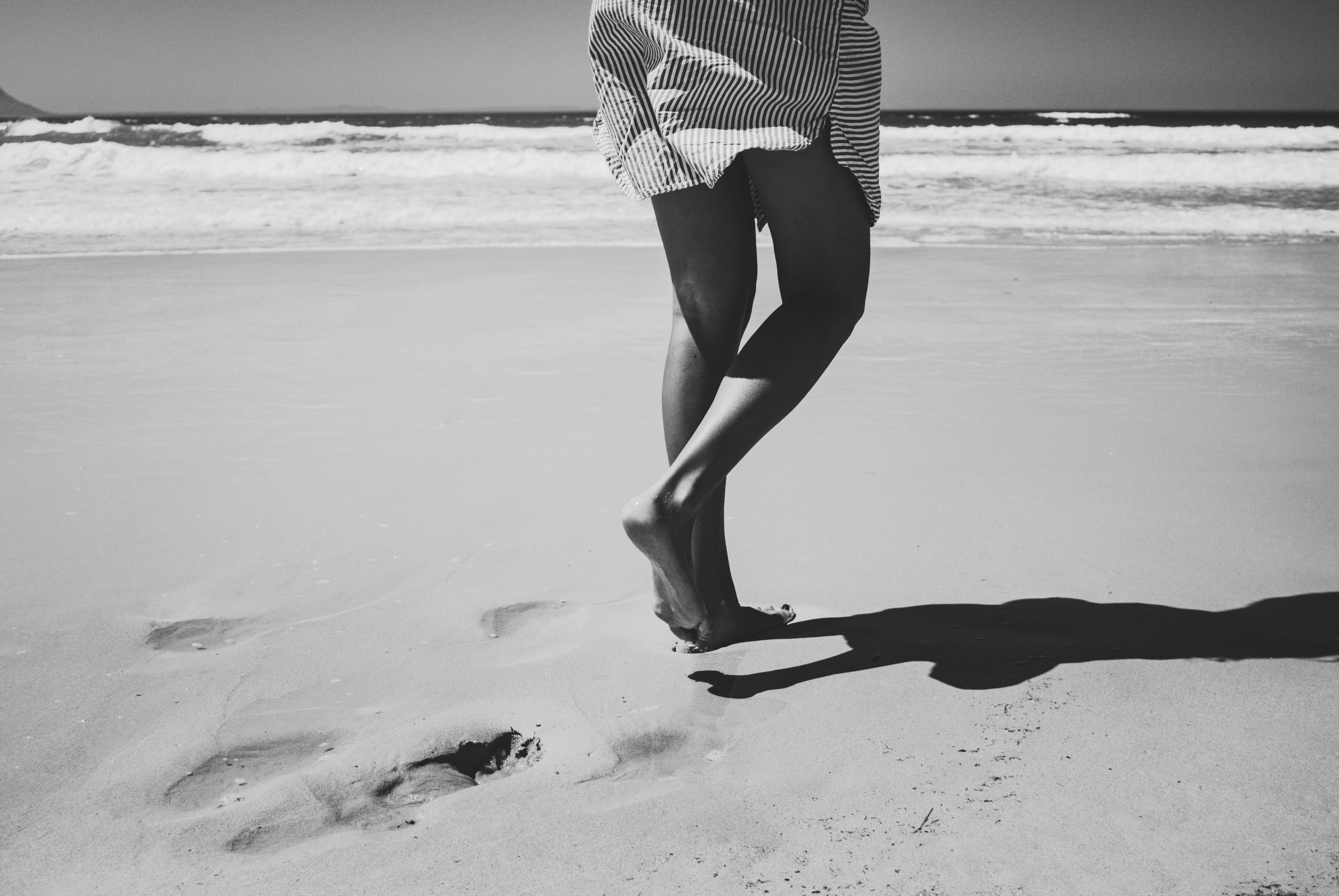 black and white, shorts, water, body part, real people, person, walking, day, photography, outdoors, low section, human limb, adult, women, sea, land, leisure activity, HD Wallpaper