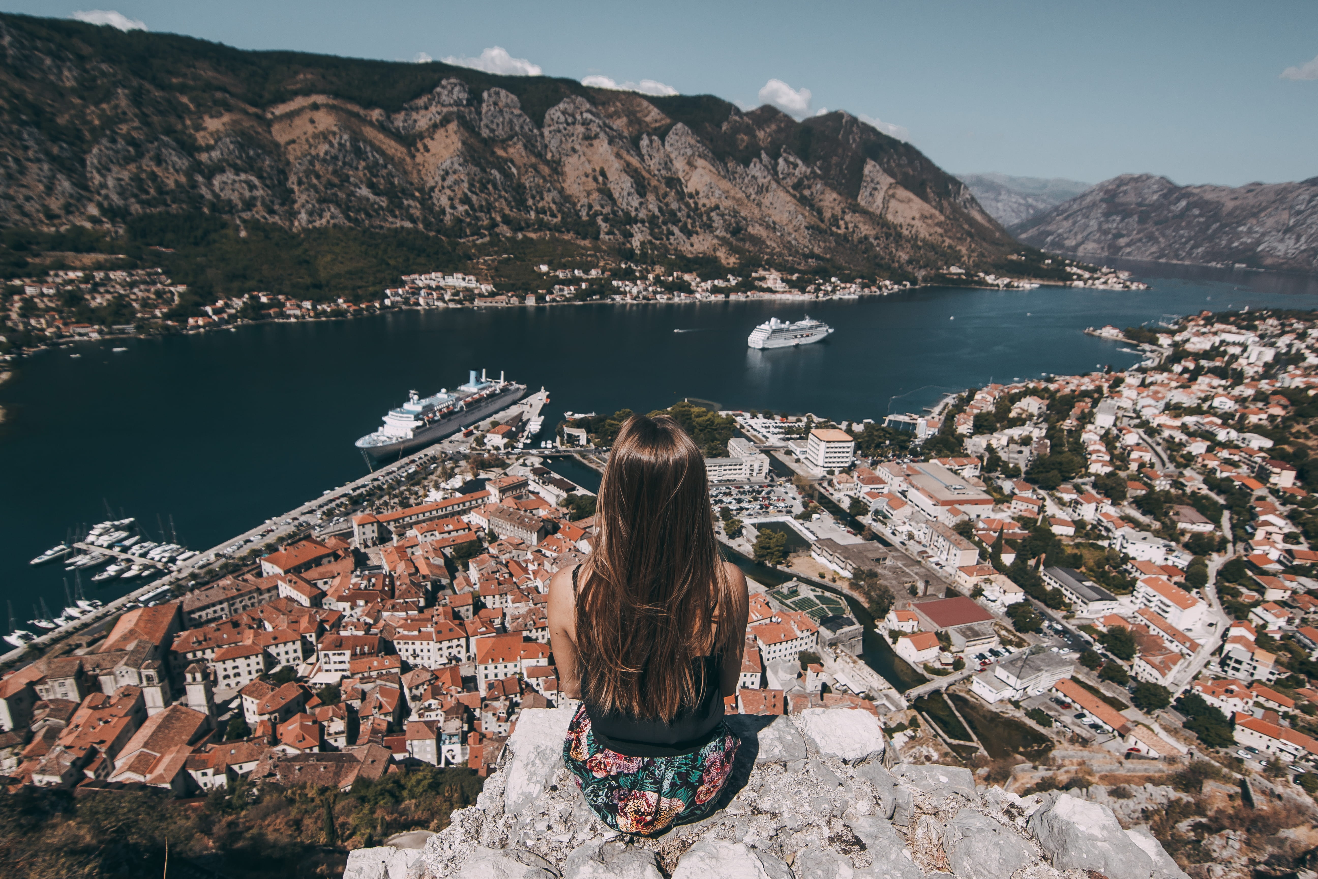 top, outdoors, day, cliff, women, gray, scenics - nature, nature, sitting, looking at view, woman, buildings, facing, rock, hairstyle, beauty in nature, HD Wallpaper