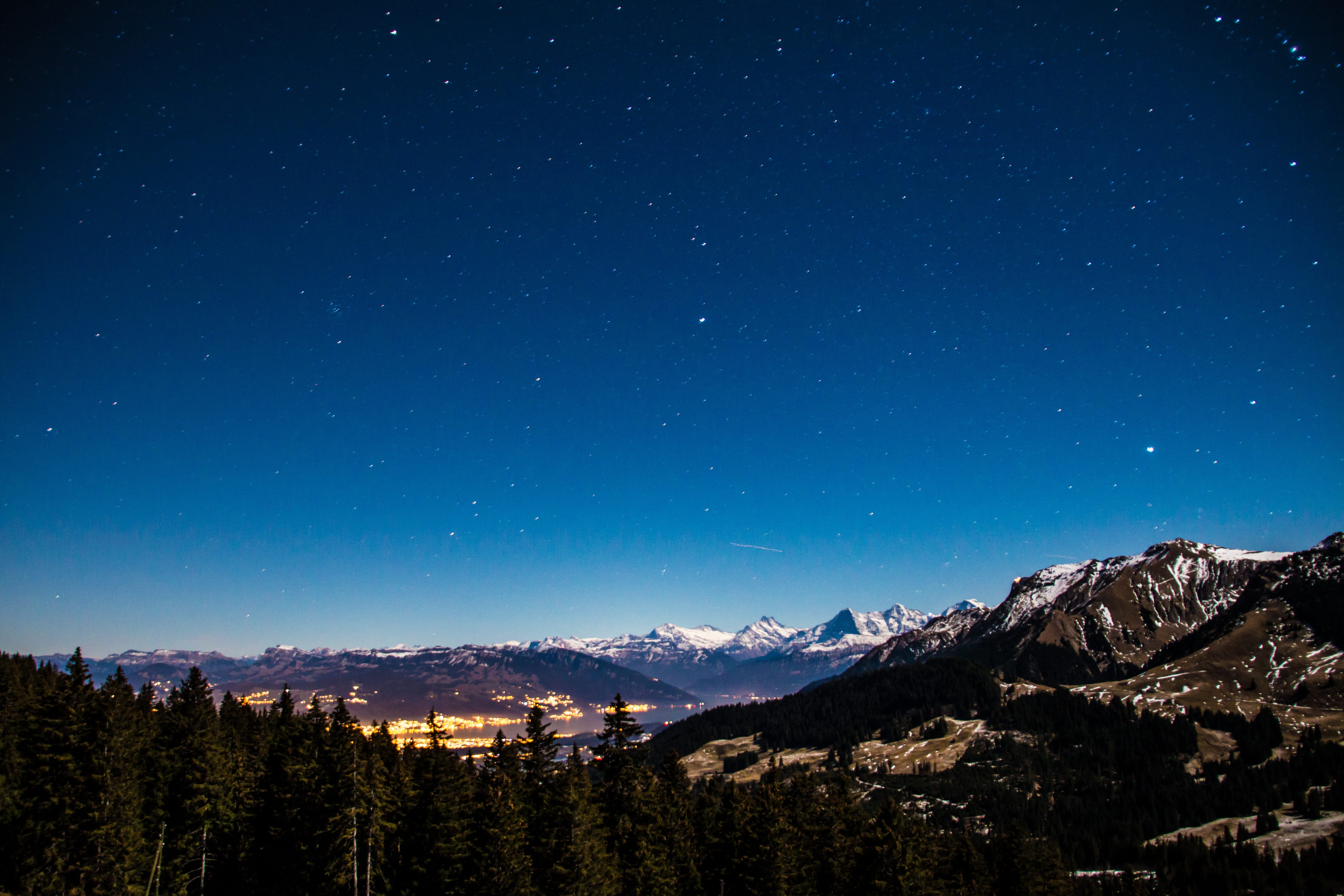 snowcapped mountain, 5K, cityscape, winter, sky, landscape, Star, night sky, night, environment, tree, long exposure, mountain range, mountains, evening sky, HD Wallpaper