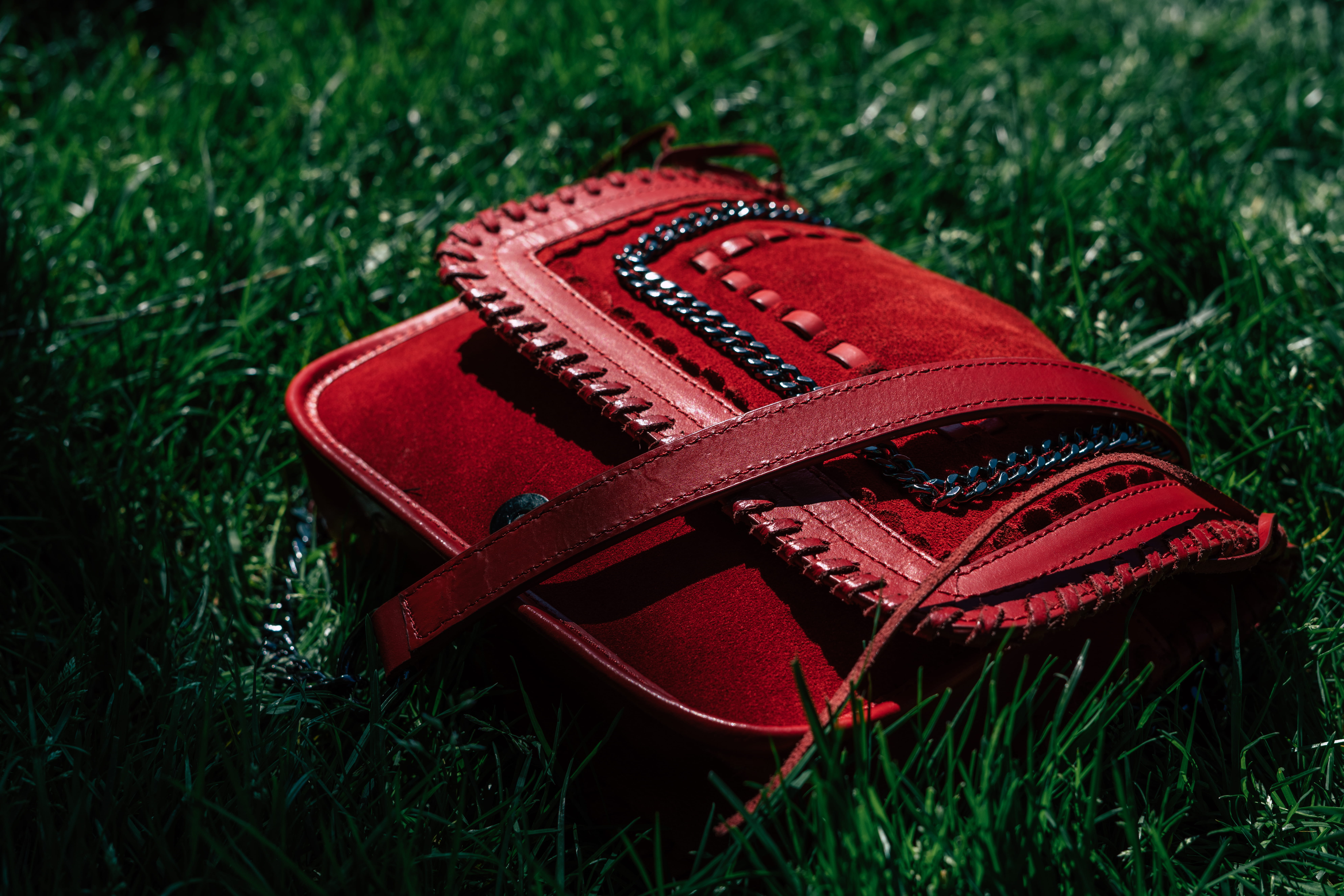 bokeh, sunlight, grass, still life, nature, bag, field, leather, clothing, purse, plant, outdoor, single object, grasses, communication, green color, high angle view, HD Wallpaper