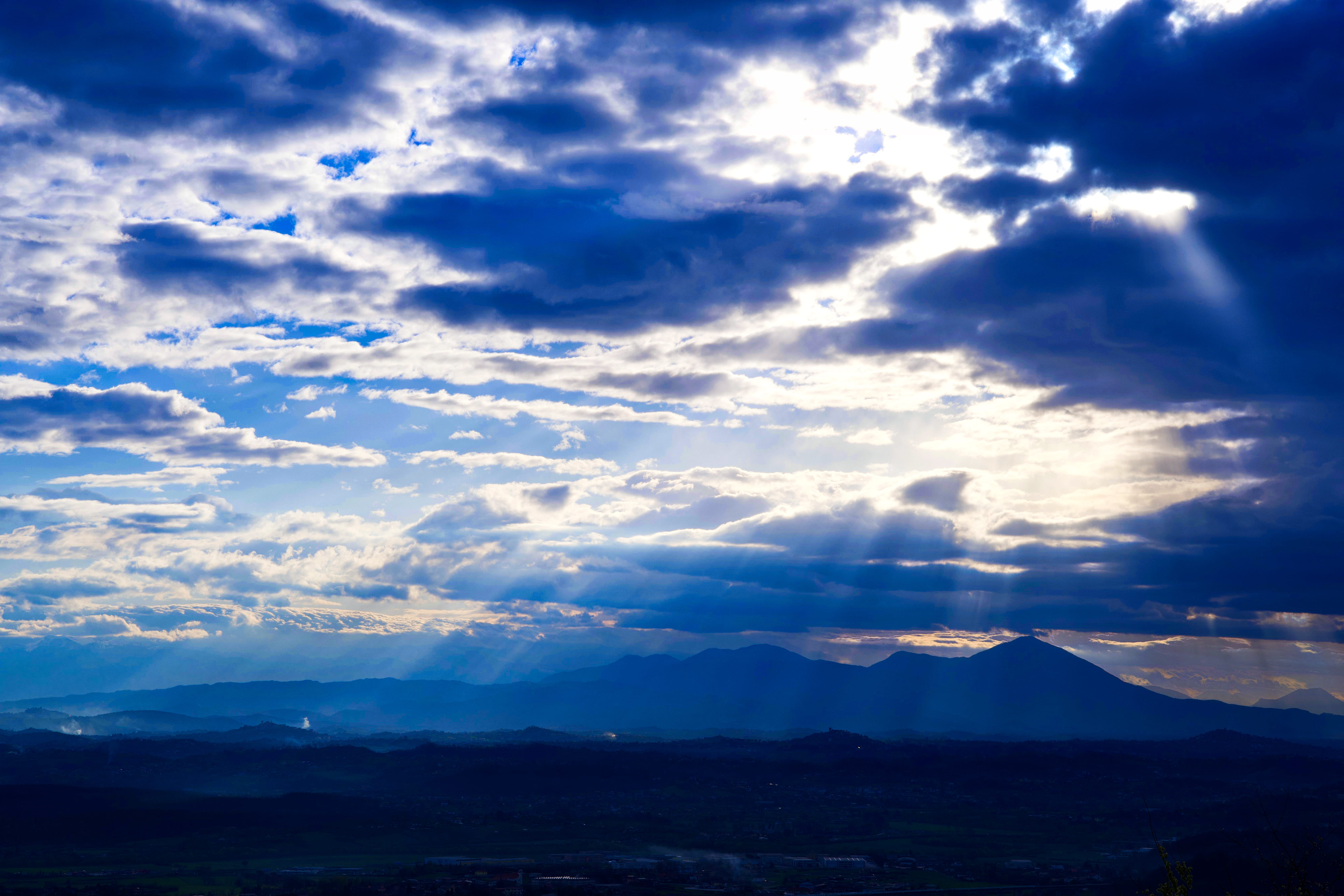 clouds, azure sky, sun, haze, cloud, no people, outdoors, tranquil scene, view, mountains, sunbeam, mountain peak, landscape, mountain range, silhouette, HD Wallpaper