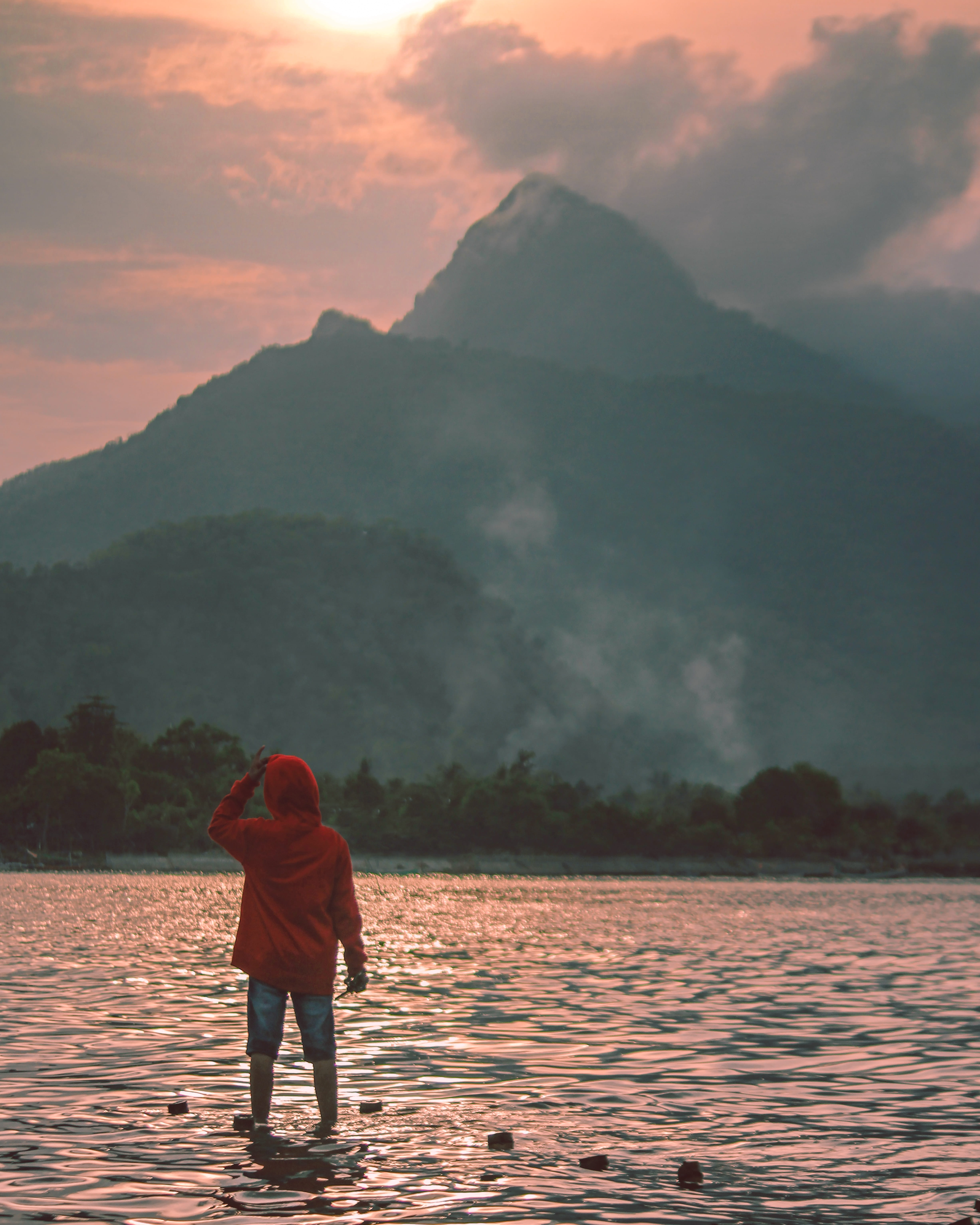 lake, ocean, sun, land, sunset, lifestyles, tranquility, rear view, standing, one person, hood, mountain range, sleeve, mountain, idyllic, coat, tranquil scene, Phone HD Wallpaper