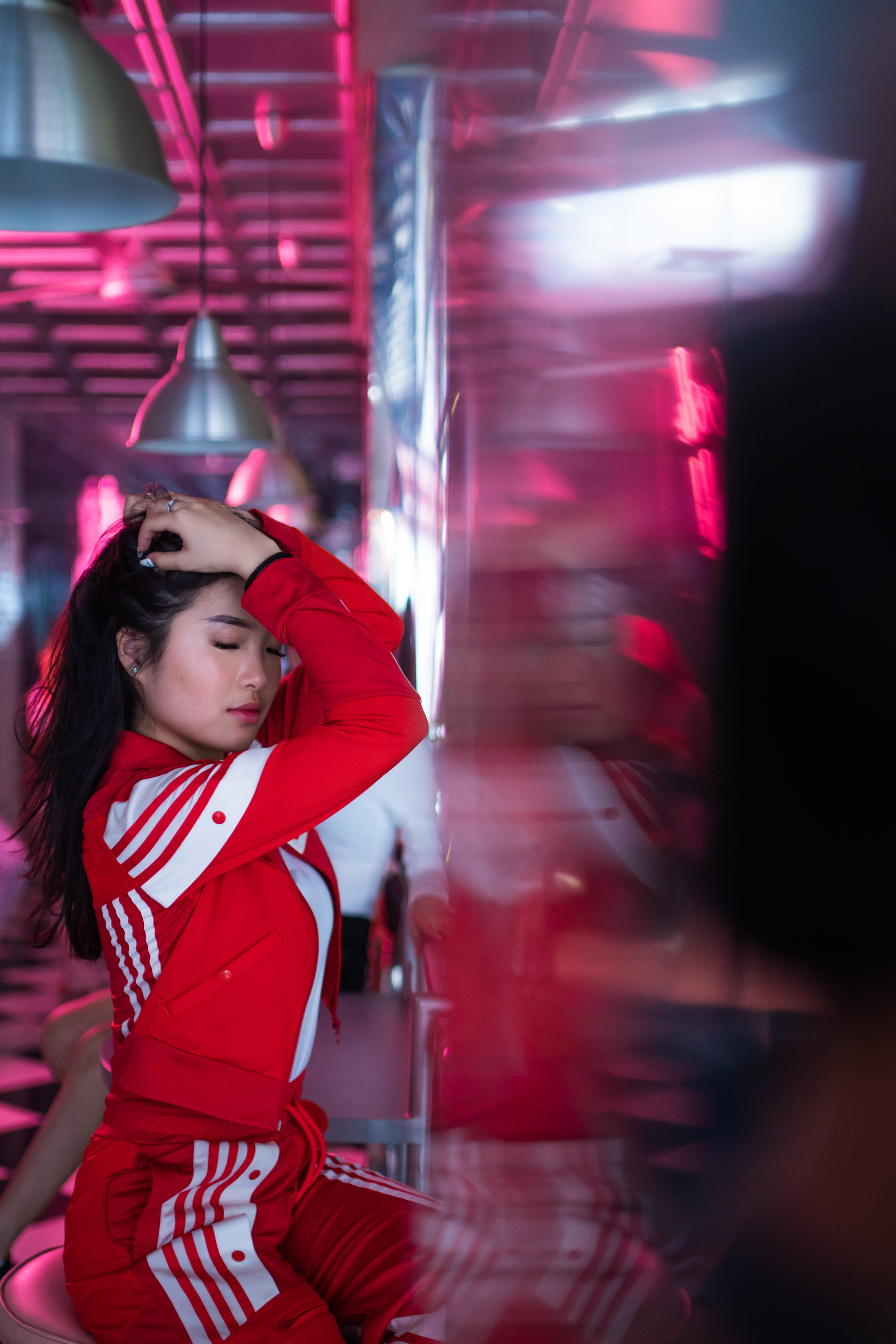 tracksuit, chair, front view, clothing, three quarter length, real people, woman, beautiful woman, casual clothing, red, women, looking, building, 5K, Phone HD Wallpaper
