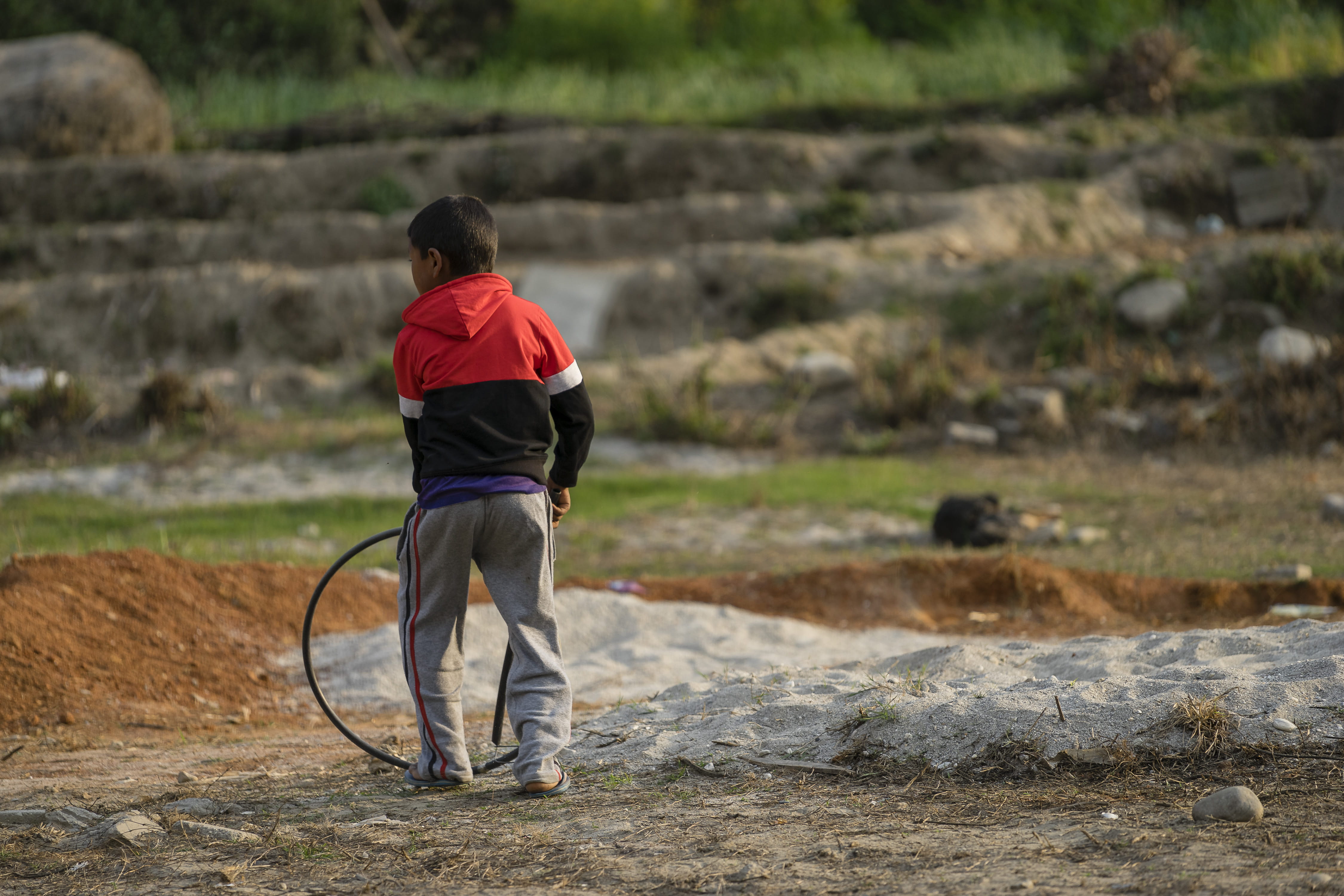 tennis racket, rock - object, hose, casual clothing, racket, full length, nepal, rear view, ground, rock, denim, boy, person, men, field, environment, land, HD Wallpaper