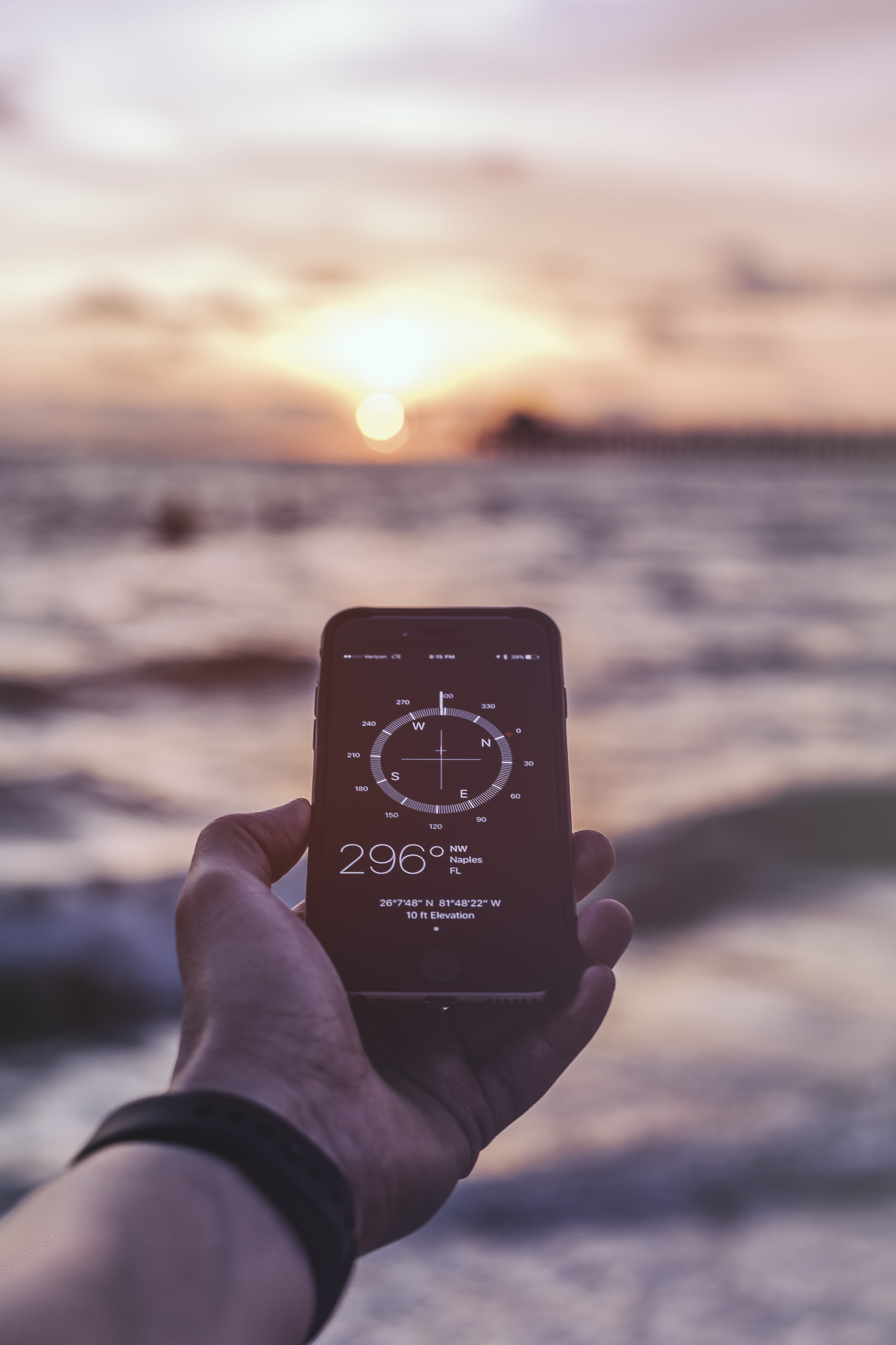 iphone, smartphone, body part, showing, sunset, unrecognizable person, sea, beach, communication, 5K, compass, reading, human hand, real people, outdoors, Phone HD Wallpaper