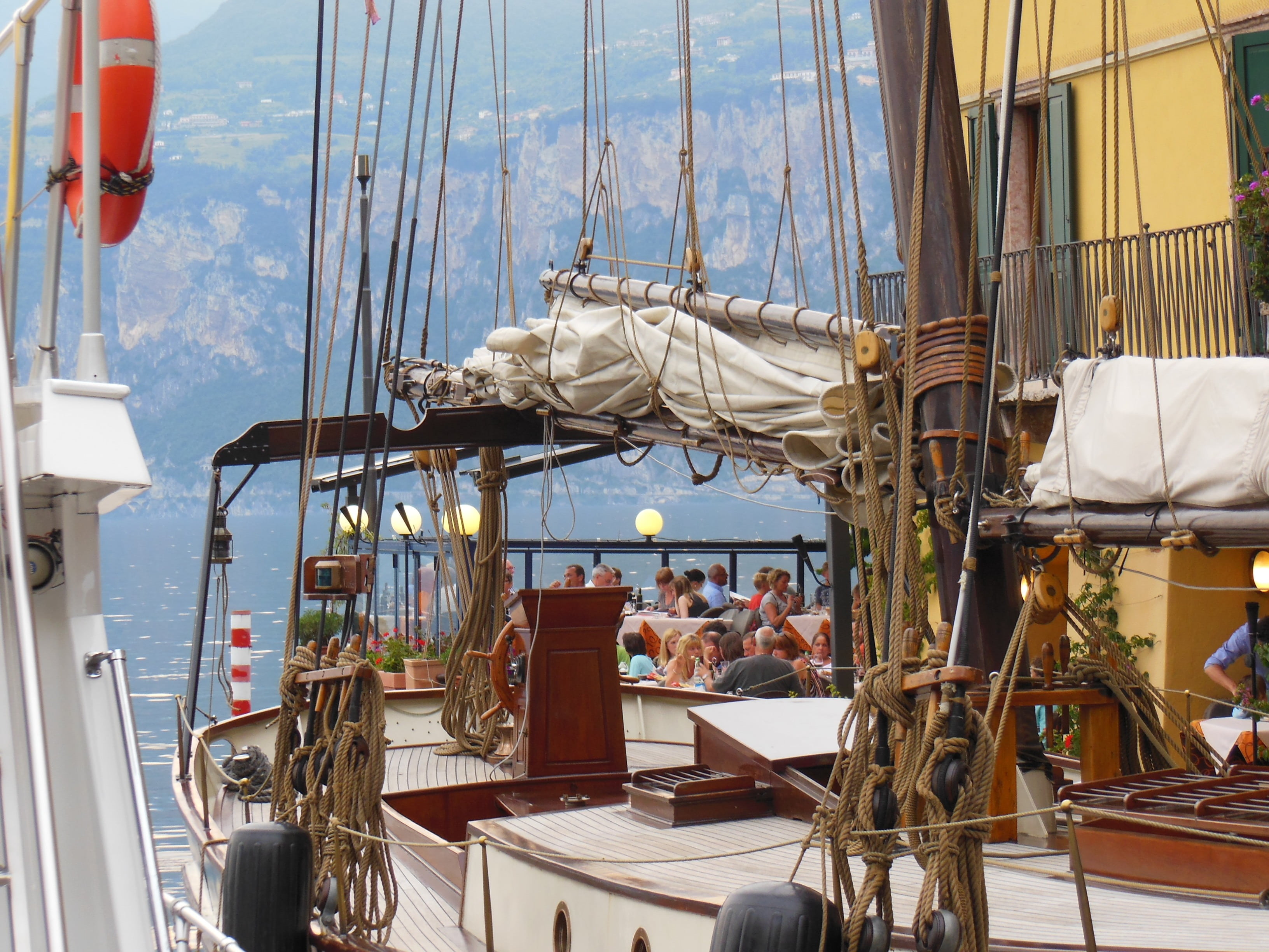 sunlight, people, nautical Vessel, malcesine, transportation, sailing Ship, rigging, harbor, ship, harbour restaurant, italy, terrace, day, sail, real people, HD Wallpaper