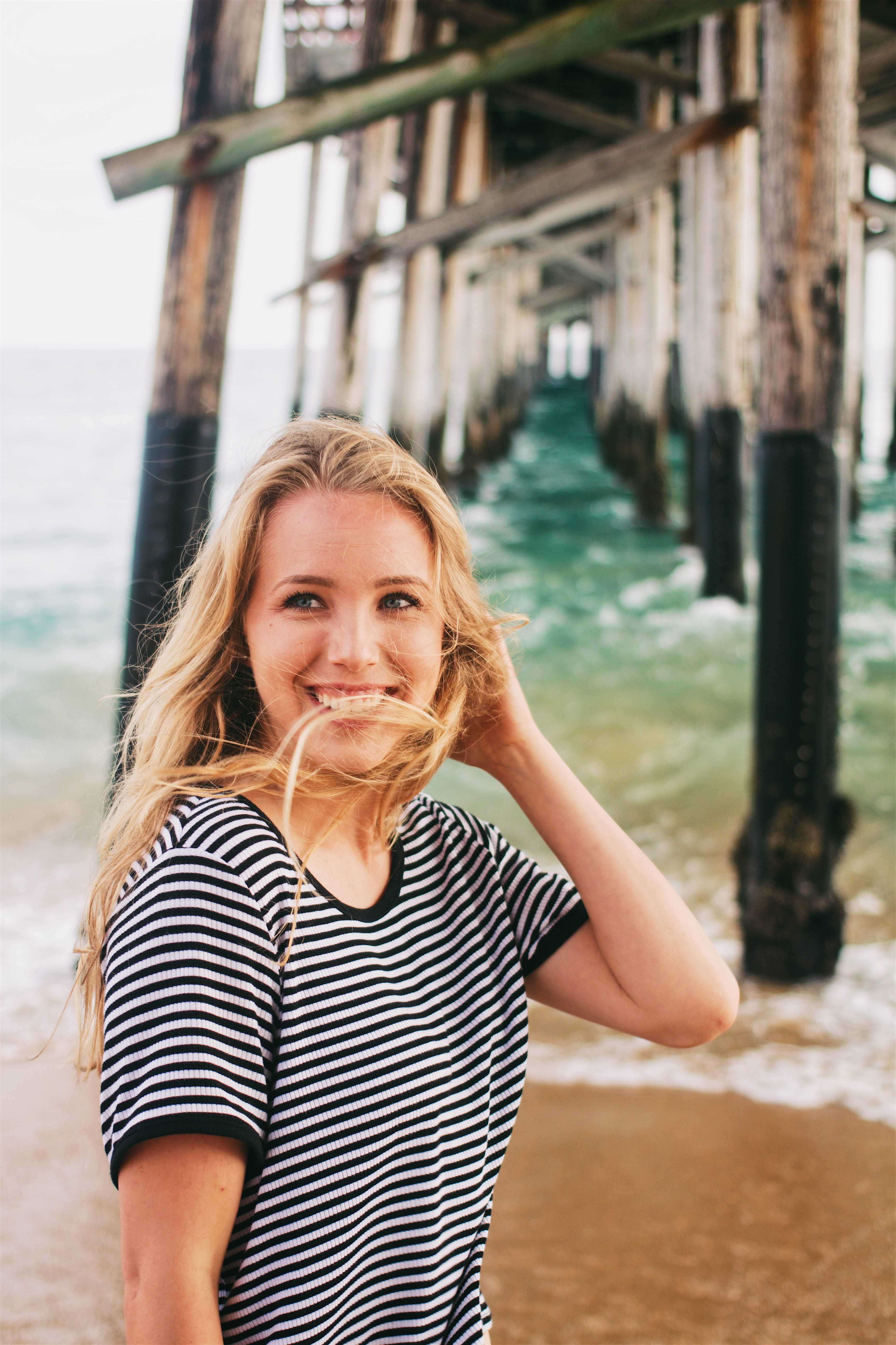 blond hair, shirt, beautiful woman, real people, girl, black, striped, hair, portrait, ringer, lifestyles, outdoors, focus on foreground, front view, water, Phone HD Wallpaper