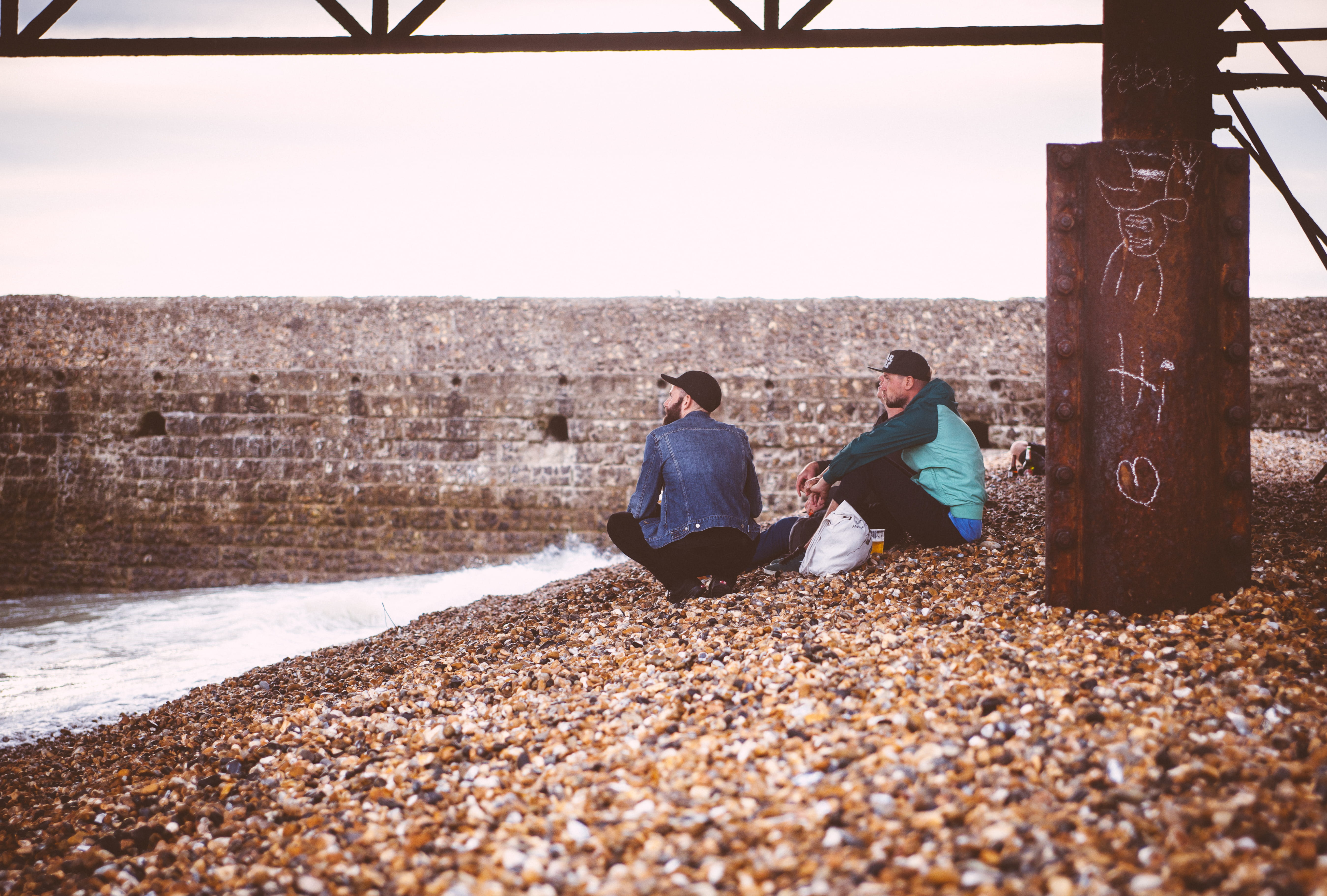 young adult, male, guy, sky, togetherness, nature, architecture, 5K, sitting, crouch, bonding, bridge, young men, real people, hanging out, hat, seaside, HD Wallpaper